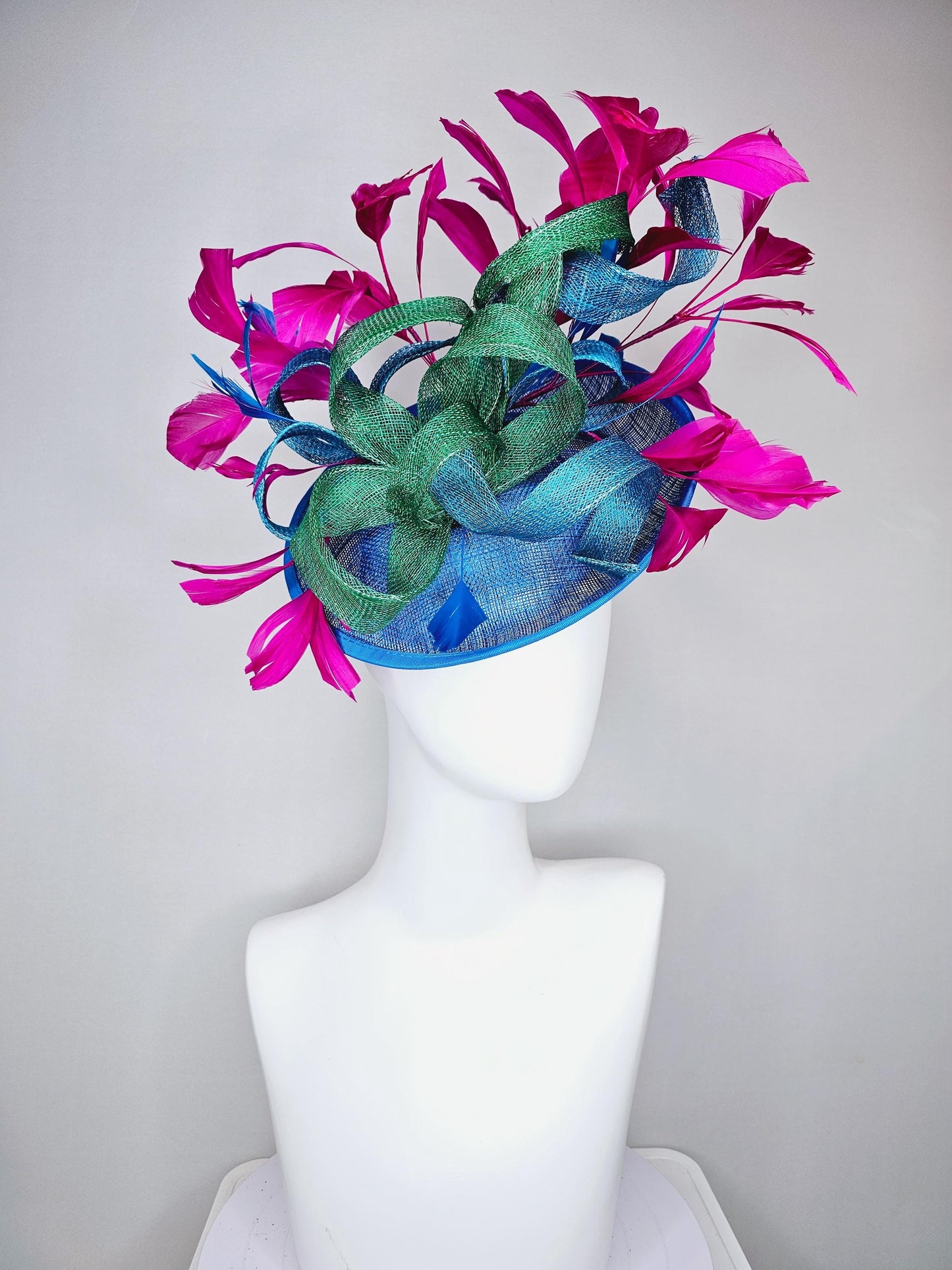 kentucky derby hat fascinator royal blue sinamay saucer with bright fuchsia hot pink branching feathers and green and blue sinamay curls