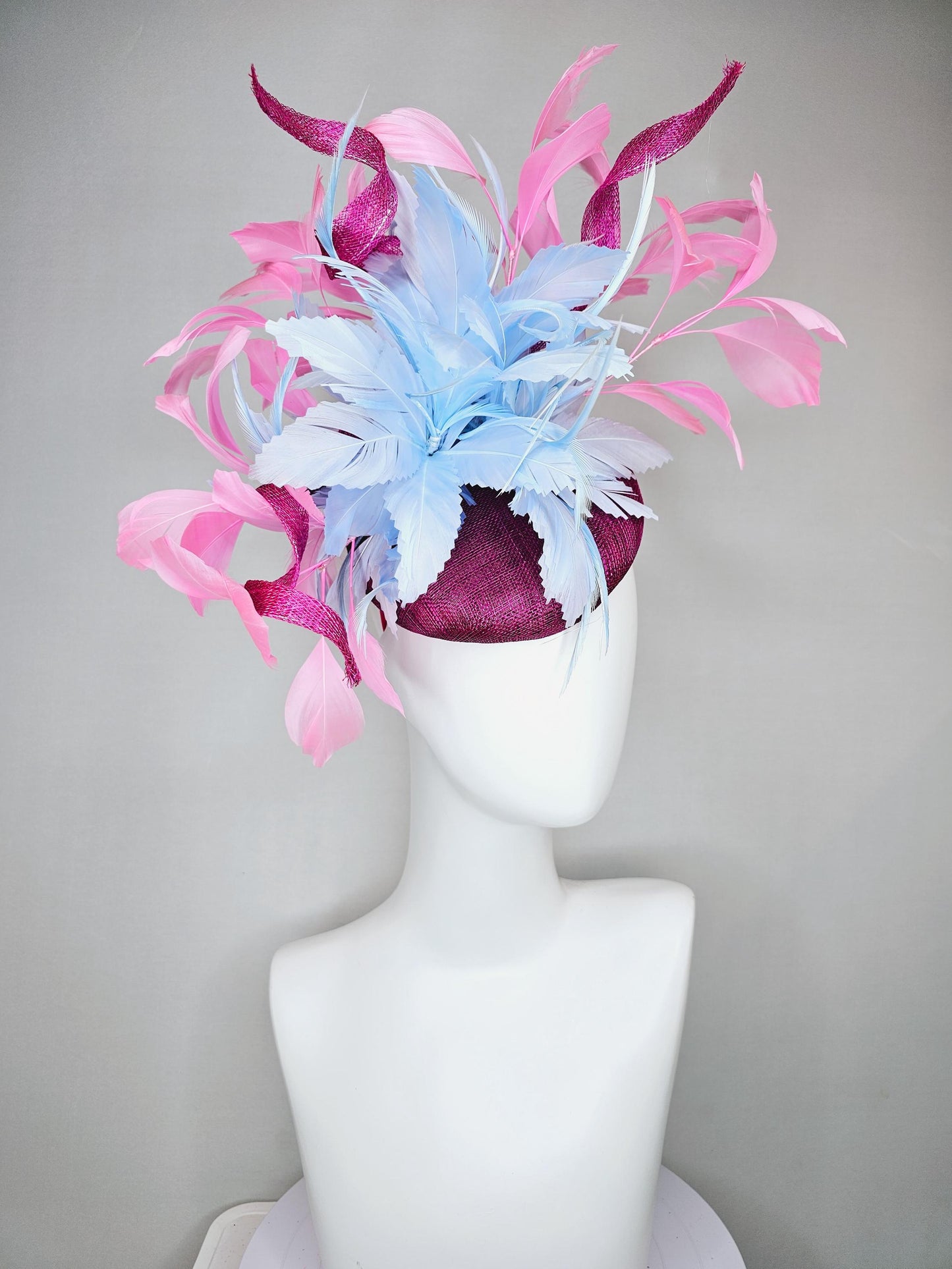 kentucky derby hat fascinator dark fuchsia purple sinamay with large light blue feather flower and light pink feathers with sinamay curls