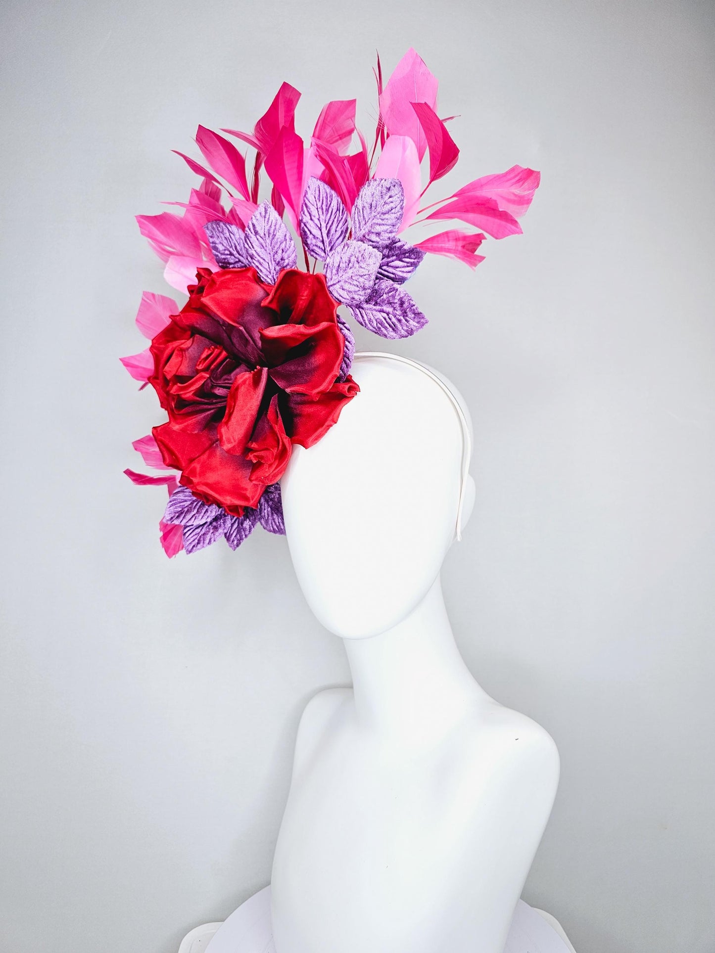 kentucky derby hat fascinator with large red satin silk flower with purple lavender velvet leaves,and branching pink feathers