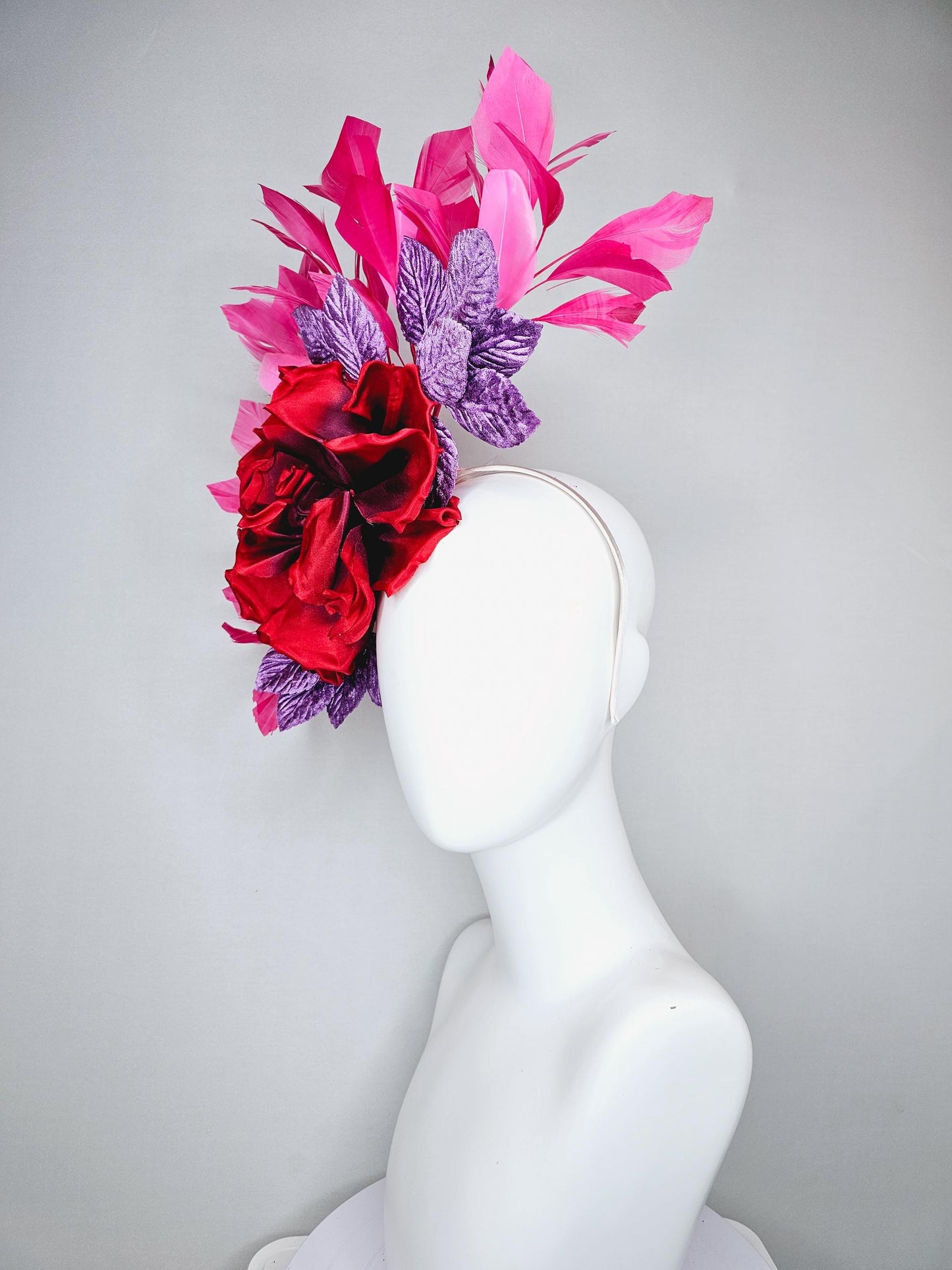 kentucky derby hat fascinator with large red satin silk flower with purple lavender velvet leaves,and branching pink feathers