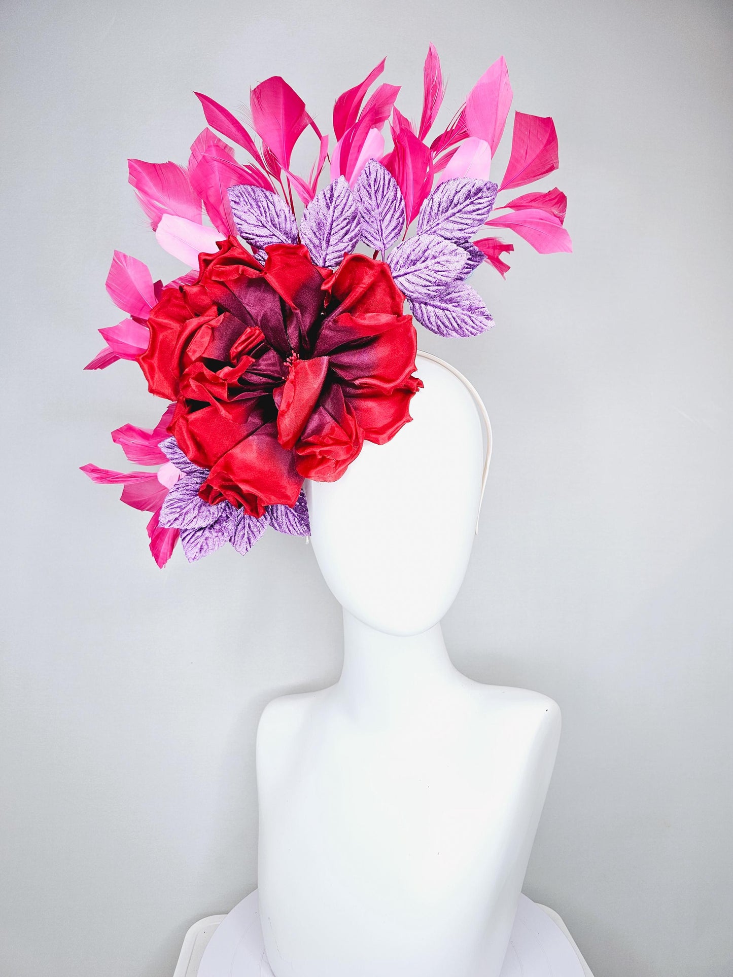 kentucky derby hat fascinator with large red satin silk flower with purple lavender velvet leaves,and branching pink feathers