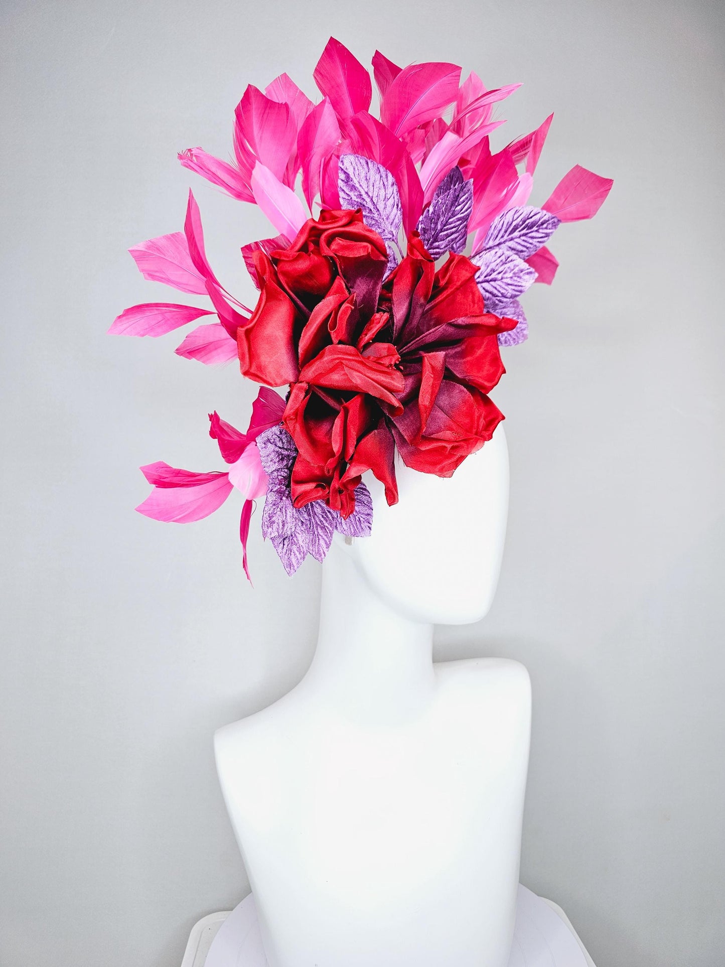 kentucky derby hat fascinator with large red satin silk flower with purple lavender velvet leaves,and branching pink feathers