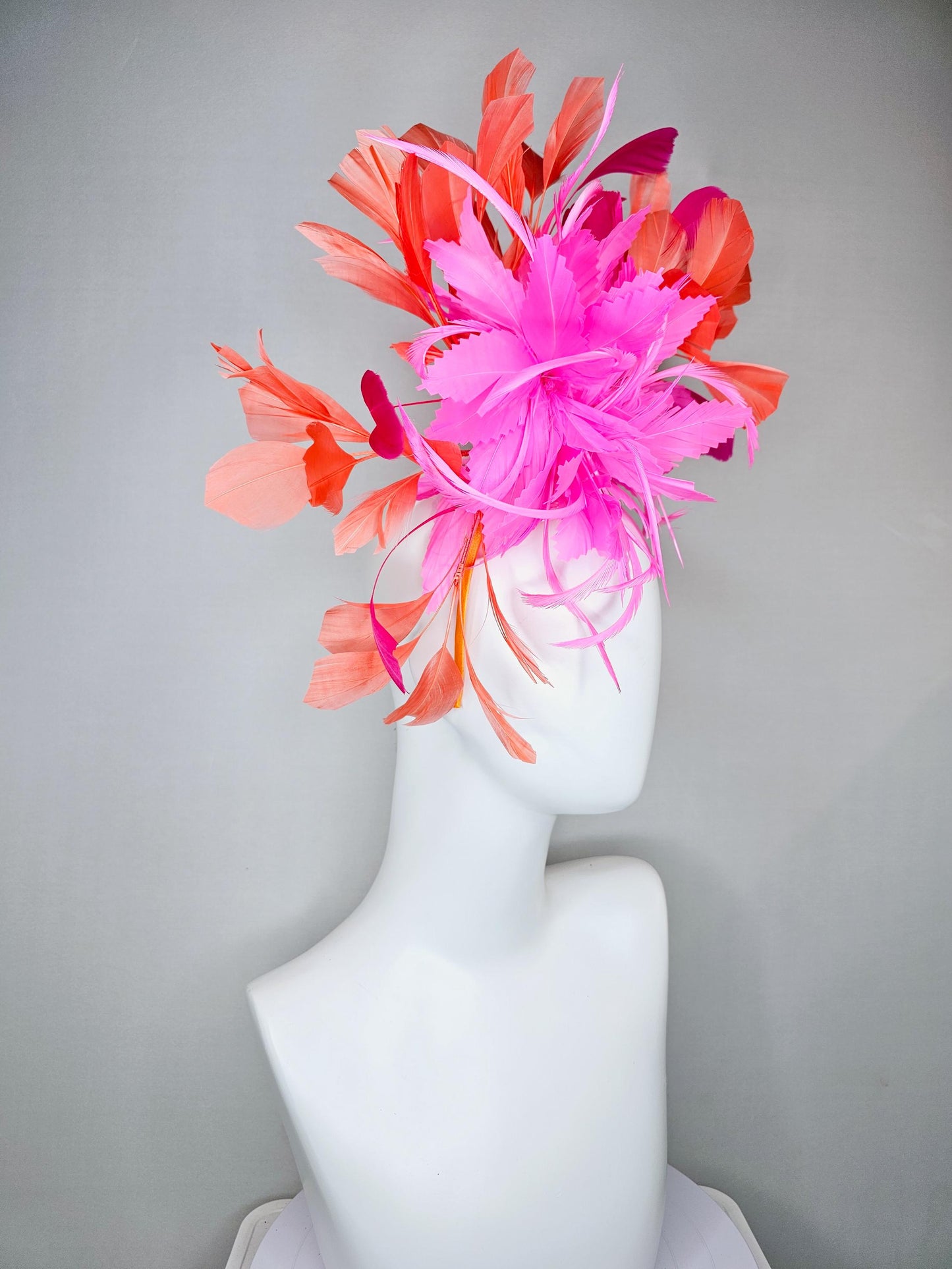 kentucky derby hat fascinator with bright pink feather flowers, fuchsia pink and orange coral branching feathers