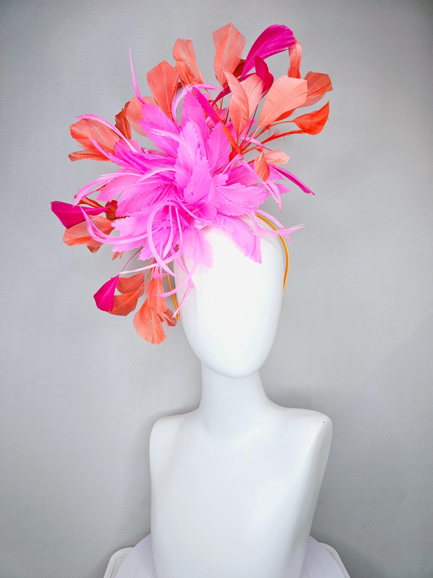kentucky derby hat fascinator with bright pink feather flowers, fuchsia pink and orange coral branching feathers