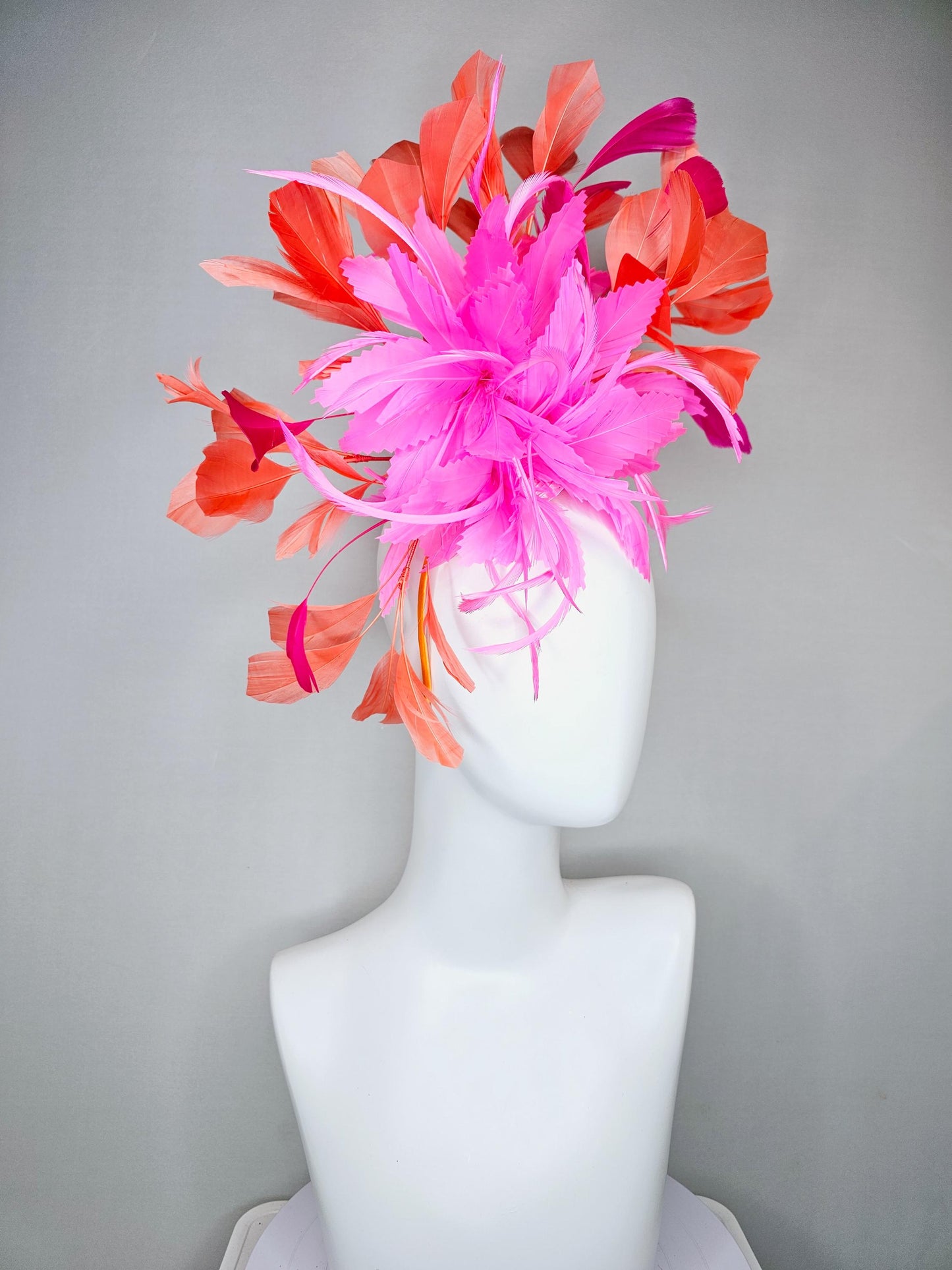 kentucky derby hat fascinator with bright pink feather flowers, fuchsia pink and orange coral branching feathers