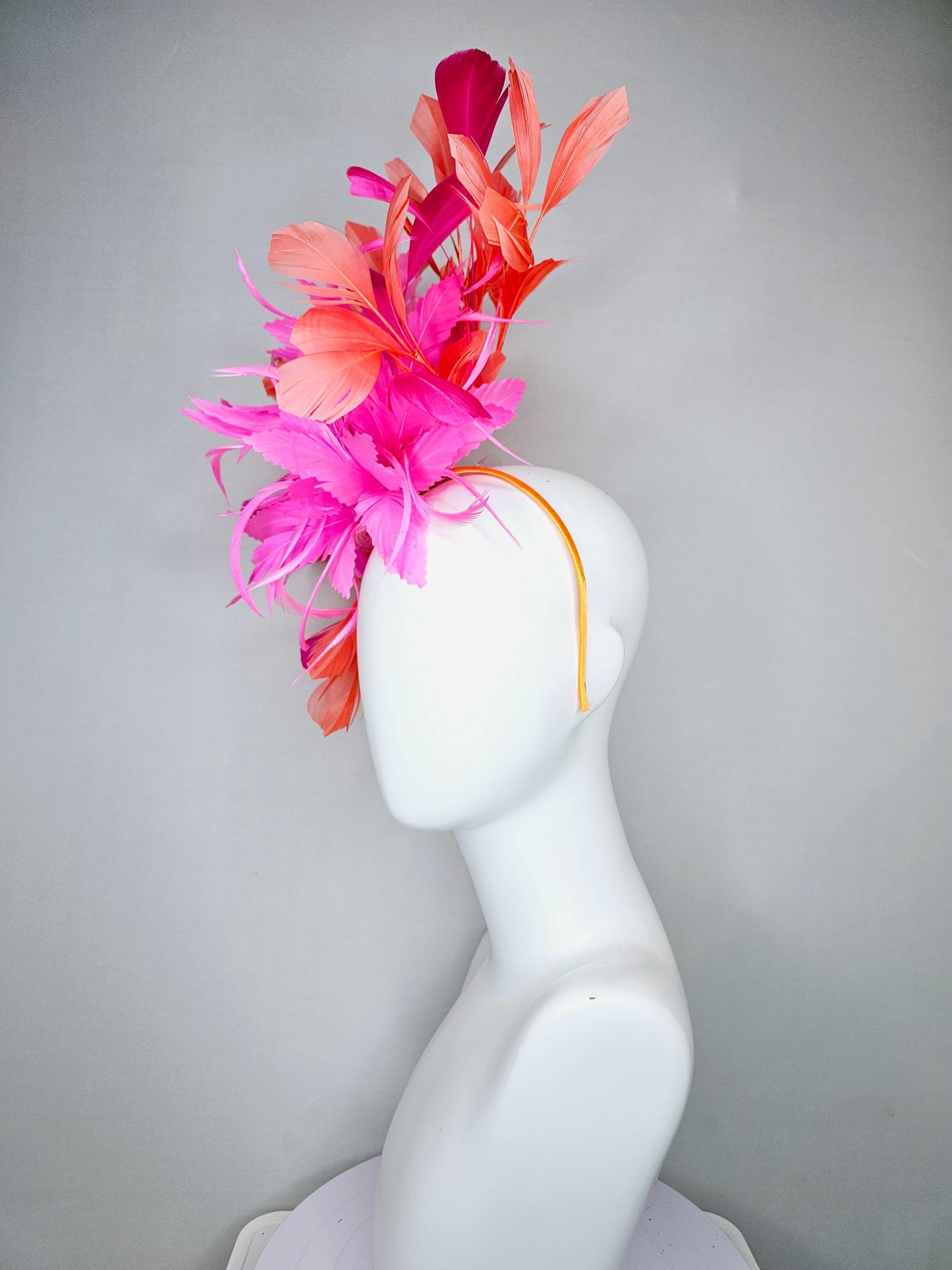 kentucky derby hat fascinator with bright pink feather flowers, fuchsia pink and orange coral branching feathers