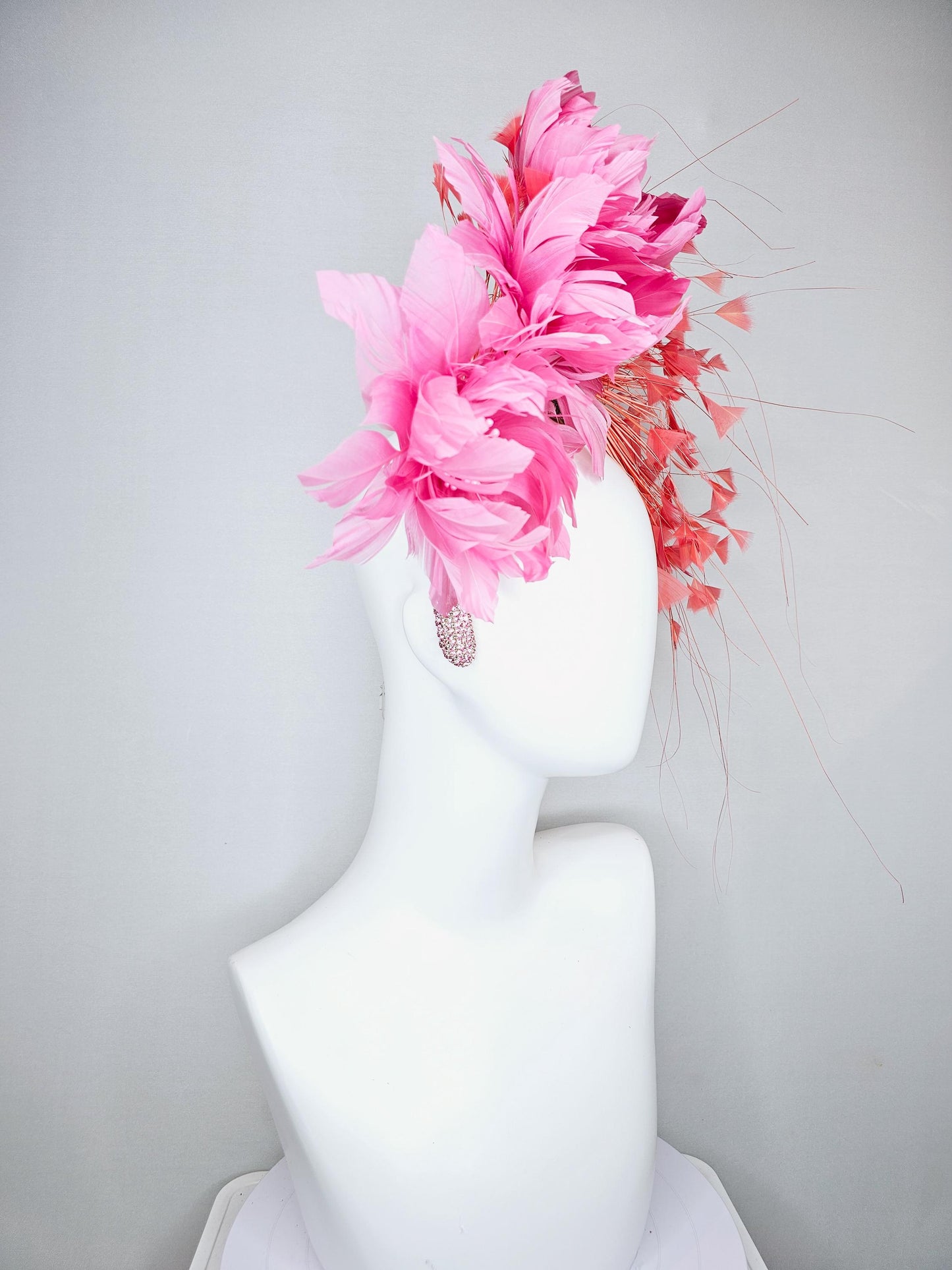kentucky derby hat fascinator with rose pink feather flowers, light orange coral branching feathers, light pink crystal rhinestone headband