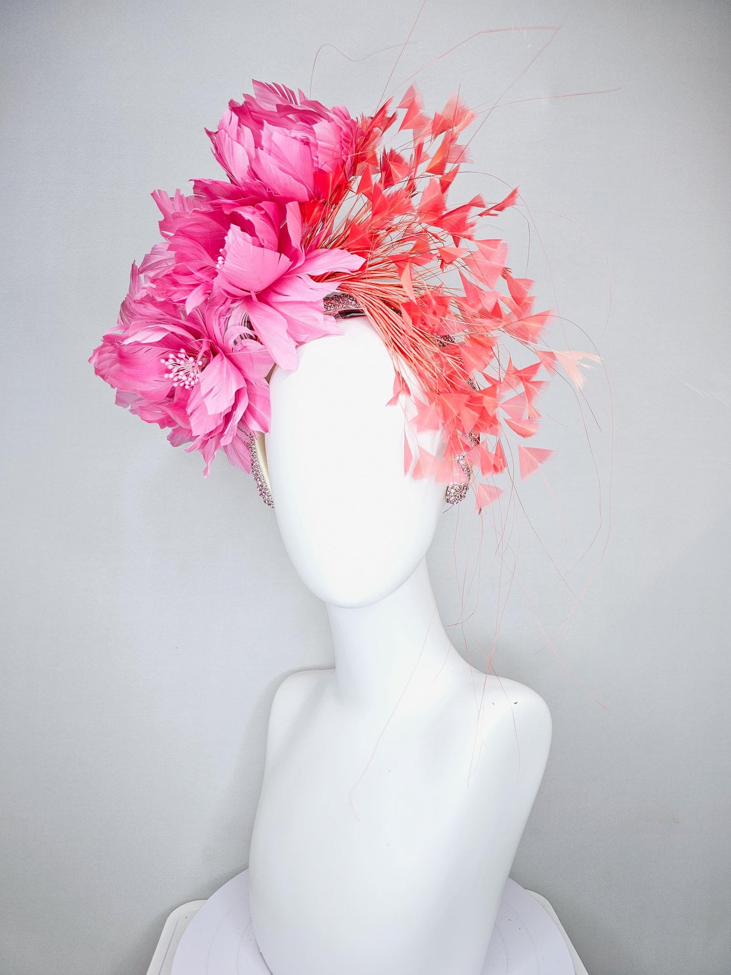 kentucky derby hat fascinator with rose pink feather flowers, light orange coral branching feathers, light pink crystal rhinestone headband