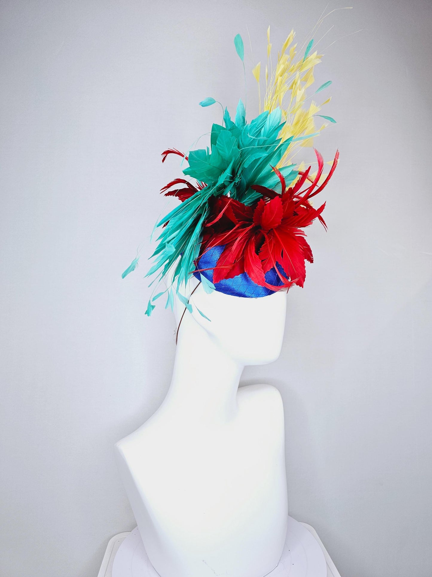 kentucky derby fascinator cobalt royal blue satin with netting,red and turquoise aqua blue feather flower,yellow branching feathers