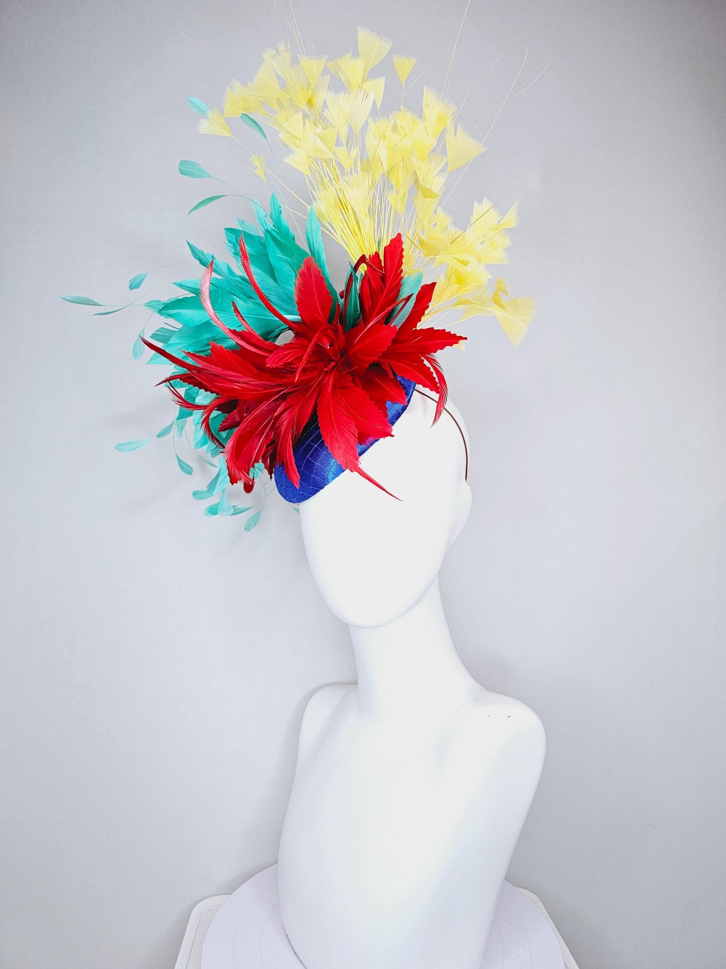 kentucky derby fascinator cobalt royal blue satin with netting,red and turquoise aqua blue feather flower,yellow branching feathers