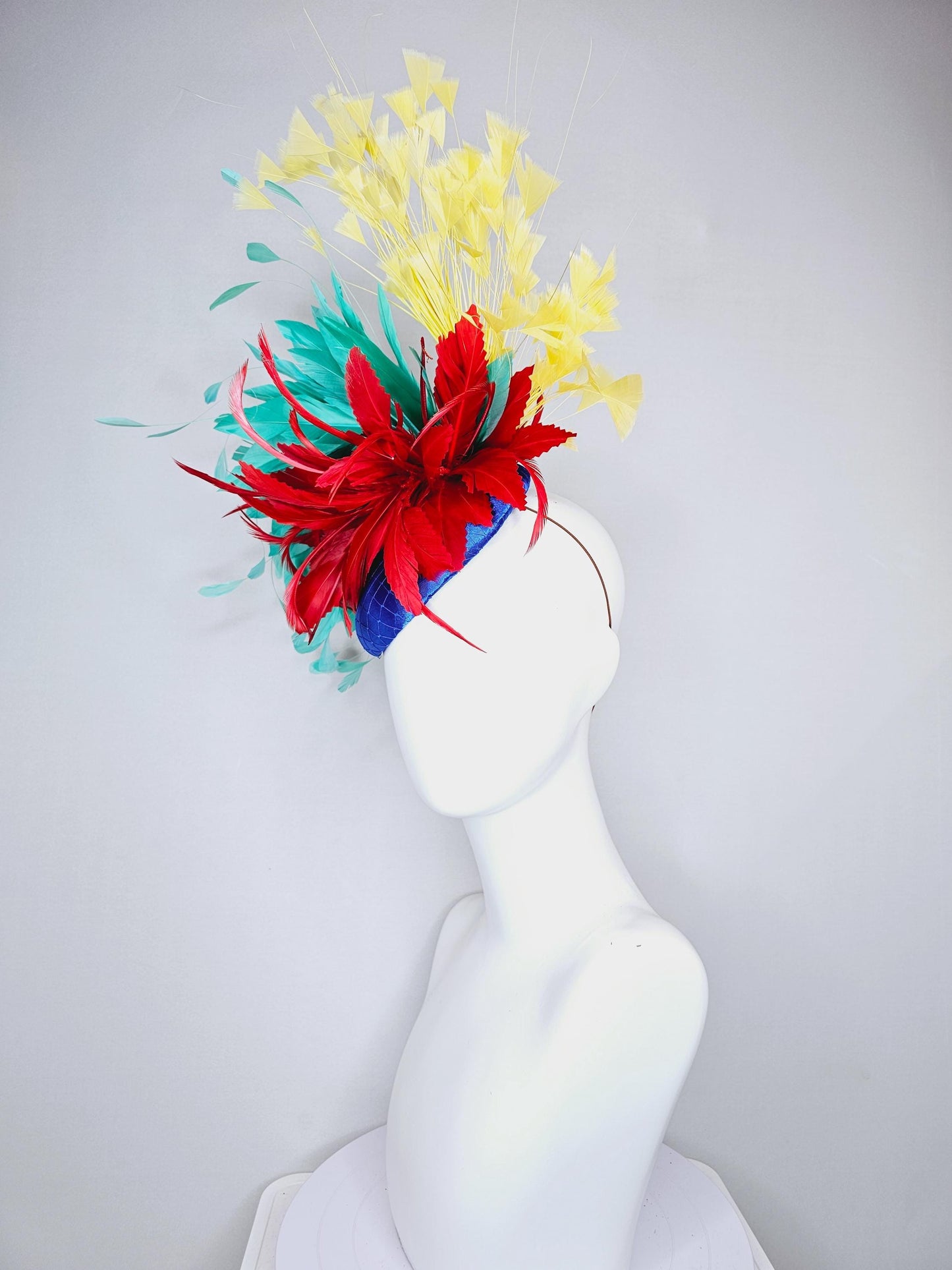 kentucky derby fascinator cobalt royal blue satin with netting,red and turquoise aqua blue feather flower,yellow branching feathers