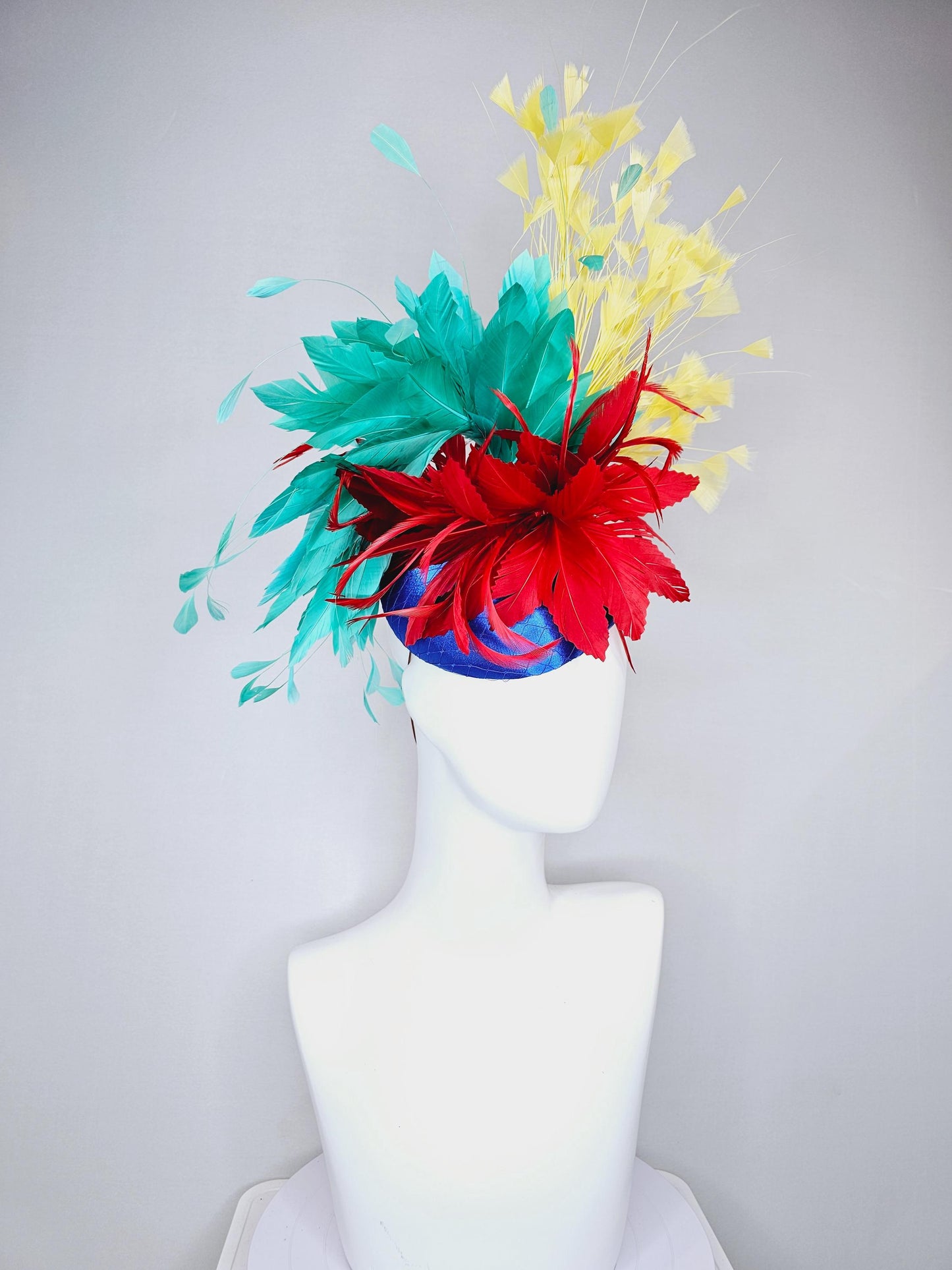 kentucky derby fascinator cobalt royal blue satin with netting,red and turquoise aqua blue feather flower,yellow branching feathers