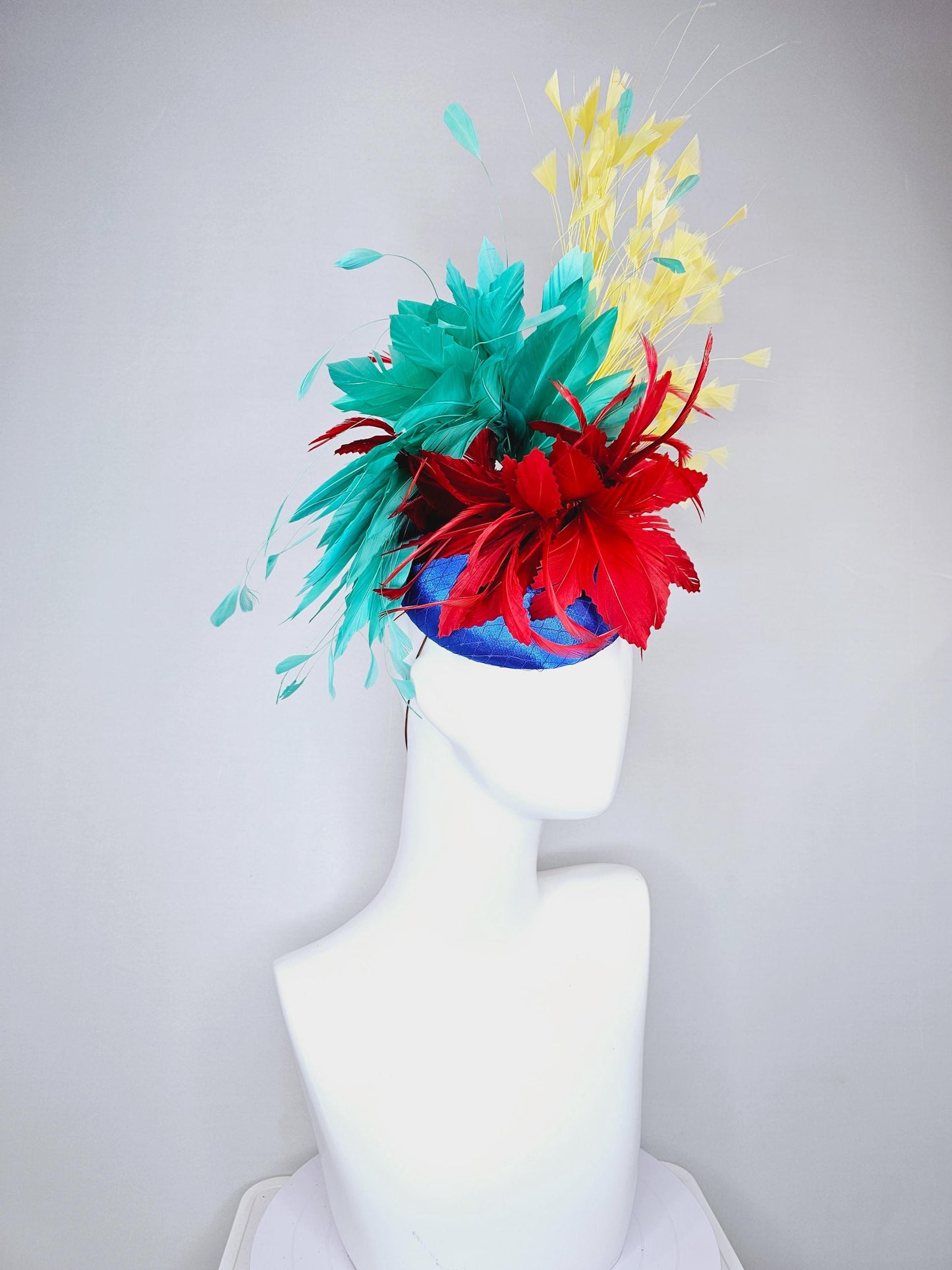 kentucky derby fascinator cobalt royal blue satin with netting,red and turquoise aqua blue feather flower,yellow branching feathers