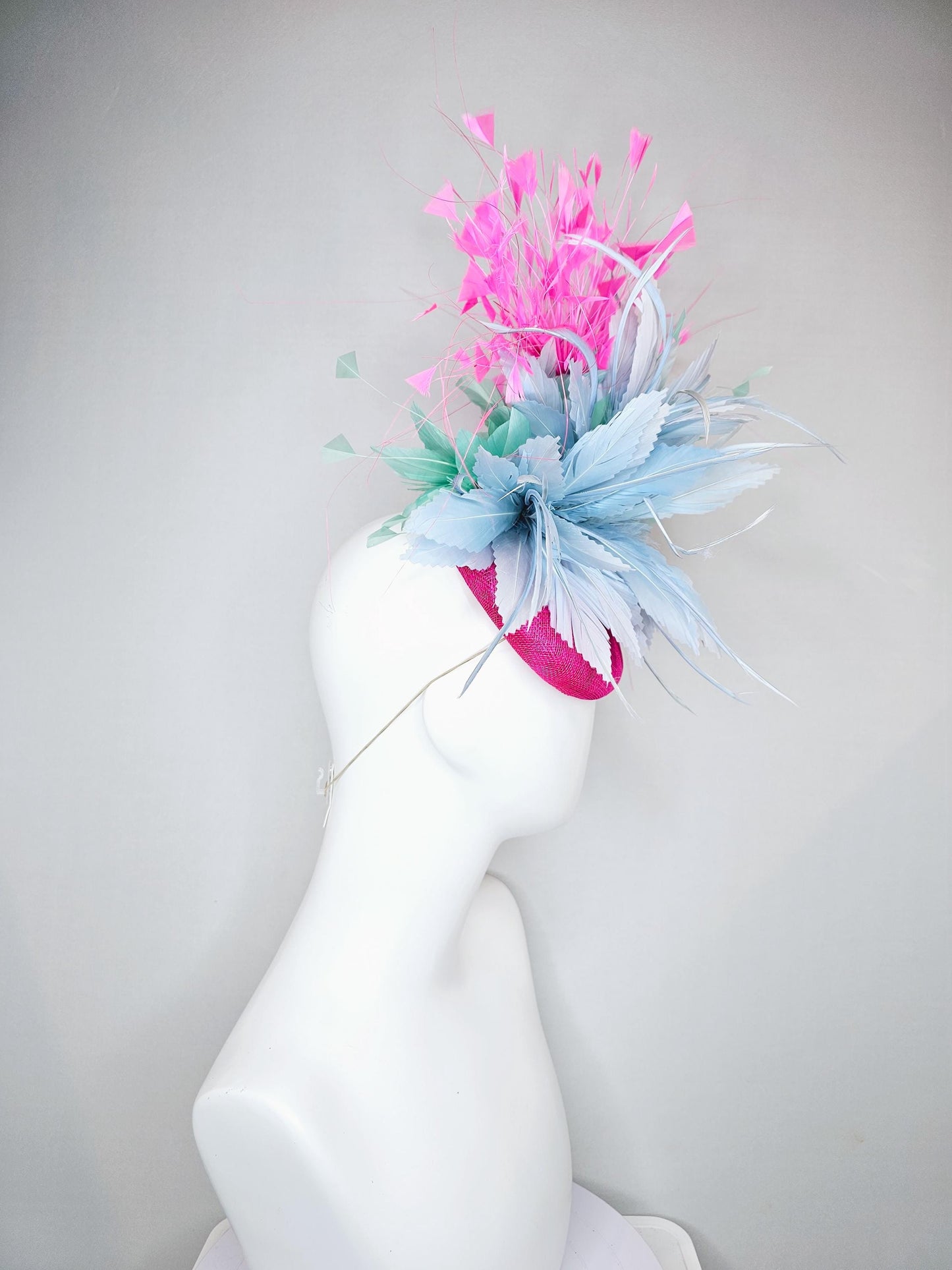 kentucky derby hat fascinator fuchsia pink sinamay with large fluffy light blue aqua blue feather flowers and blush pink branching feathers