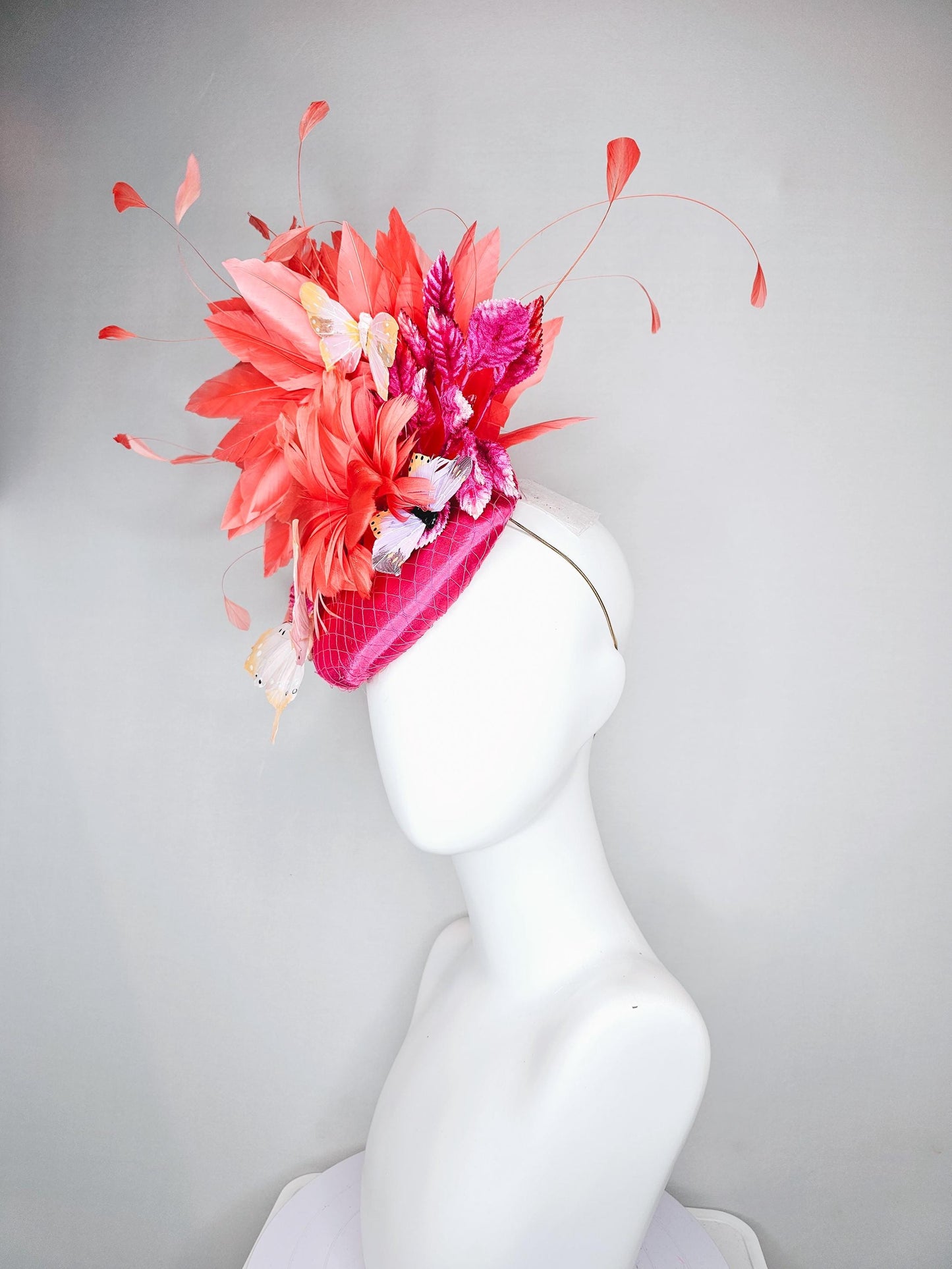 kentucky derby hat fascinator pink satin with netting,orange coral feather flower,pink leaves,orange branching feathers,white butterflies