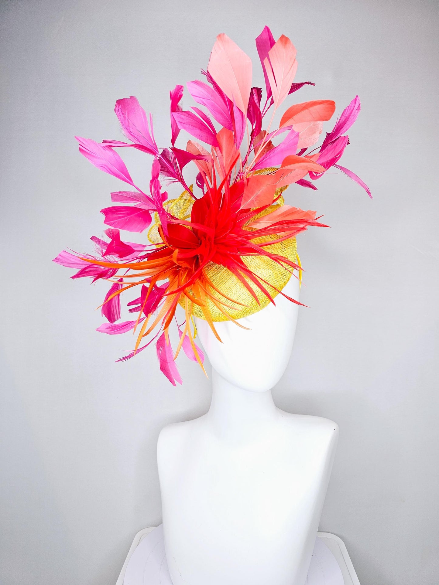 kentucky derby hat fascinator yellow sinamay and curls with bright red feather flower with branching orange, coral, peach and pink feathers