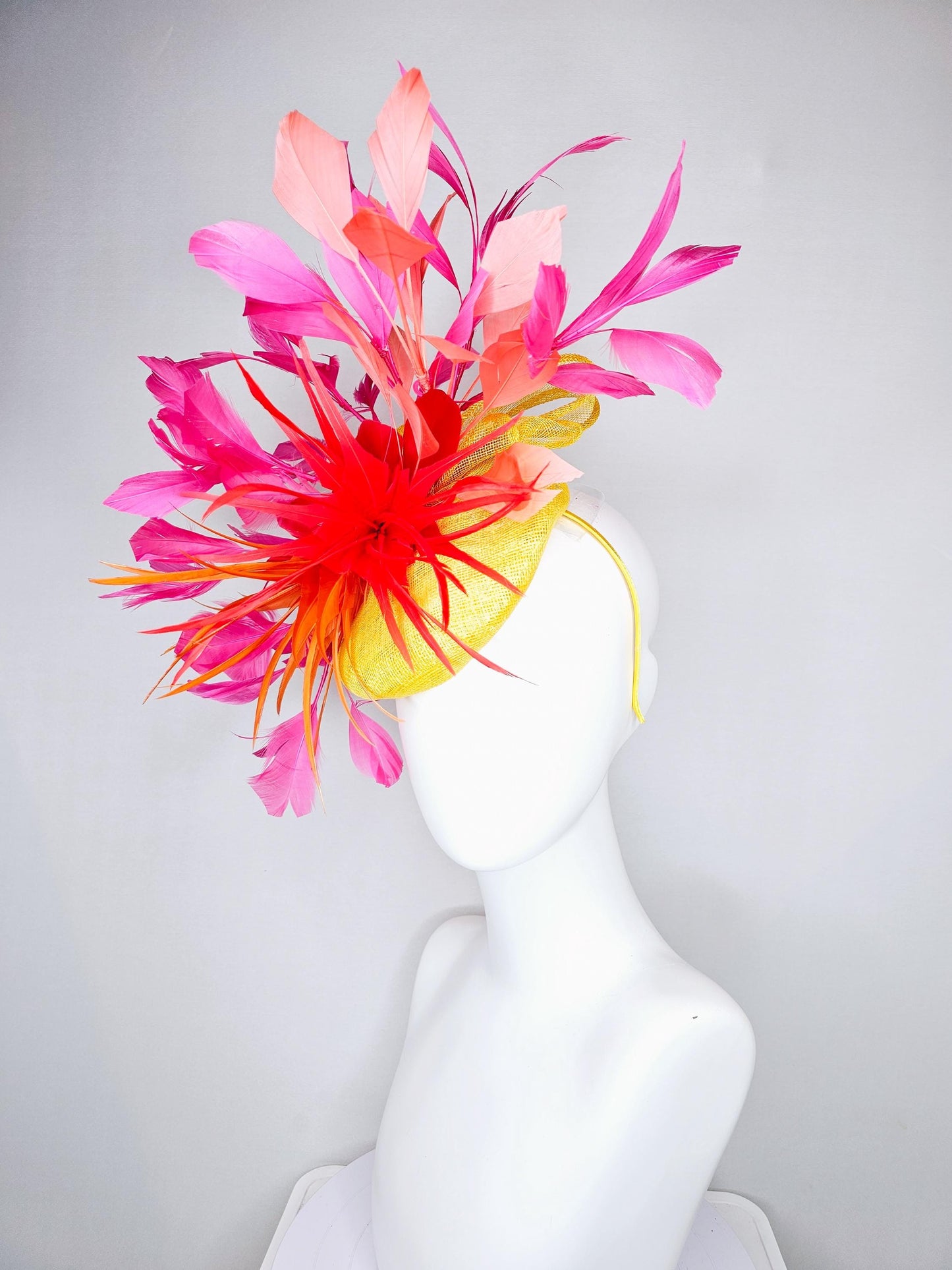 kentucky derby hat fascinator yellow sinamay and curls with bright red feather flower with branching orange, coral, peach and pink feathers