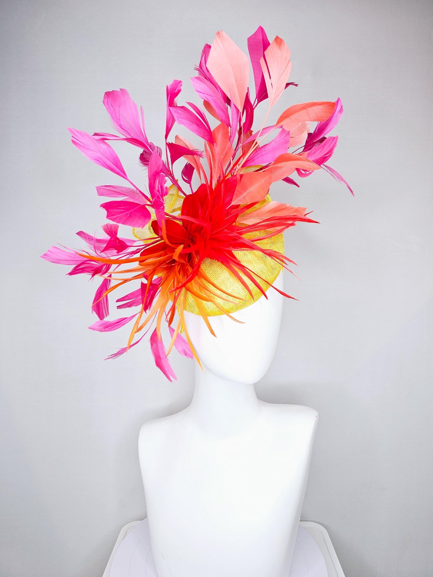kentucky derby hat fascinator yellow sinamay and curls with bright red feather flower with branching orange, coral, peach and pink feathers