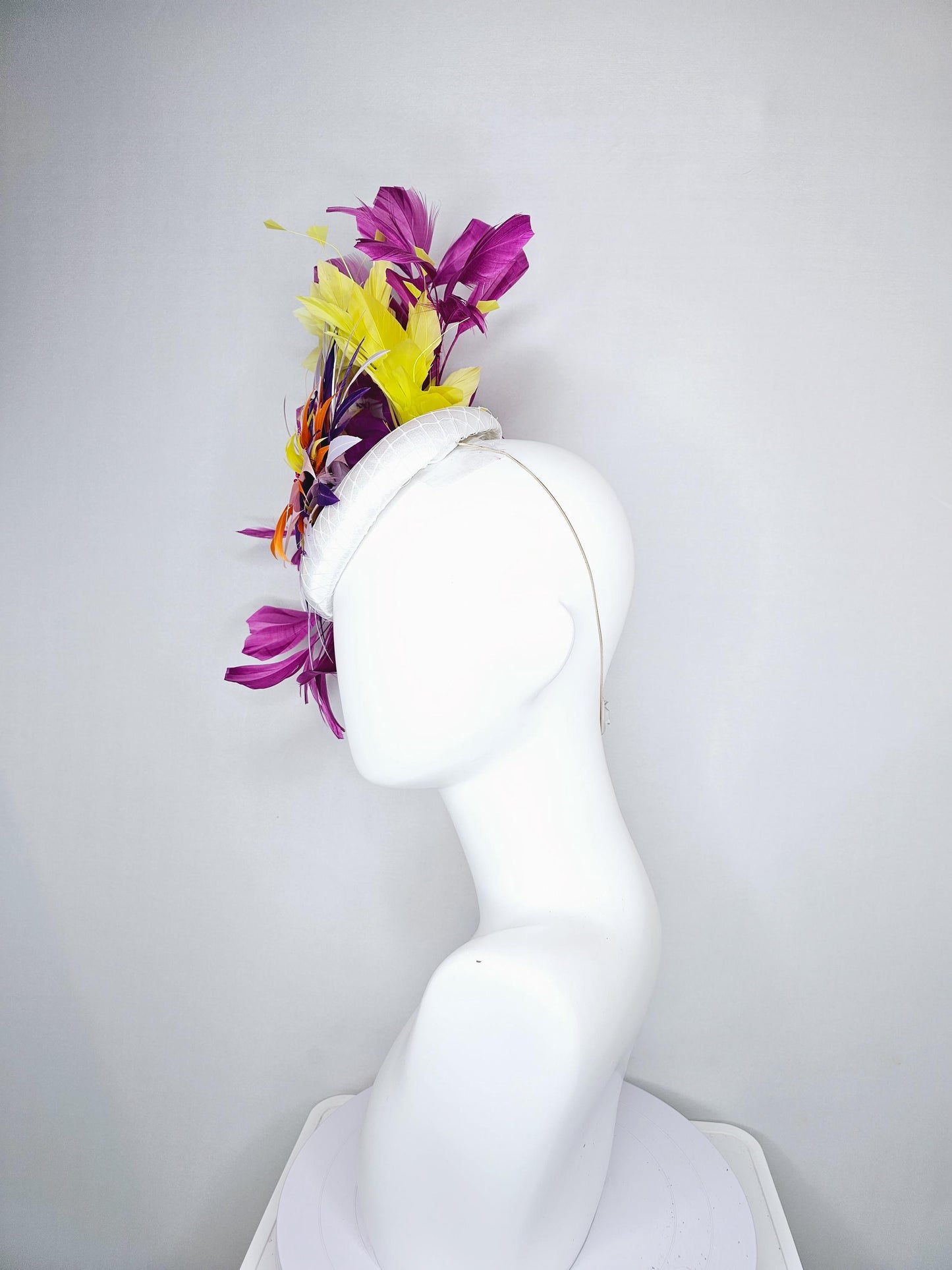 kentucky derby hat fascinator white satin with netting, orange yellow white purple feather flower, yellow purple magenta branching feathers