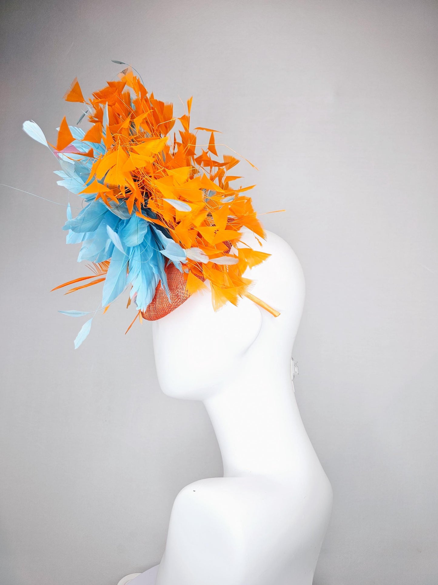 kentucky derby hat fascinator orange sinamay with bright orange, sky blue and light pink branching feathers