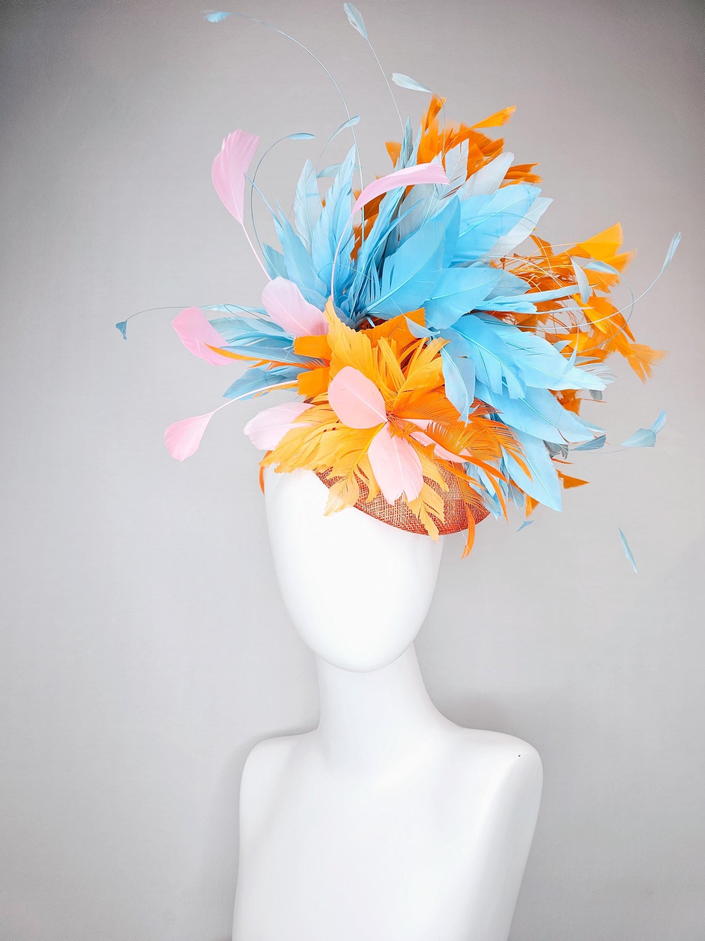 kentucky derby hat fascinator orange sinamay with bright orange, sky blue and light pink branching feathers