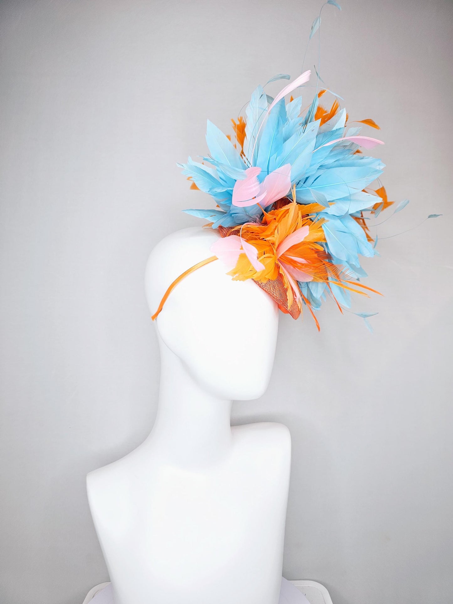 kentucky derby hat fascinator orange sinamay with bright orange, sky blue and light pink branching feathers