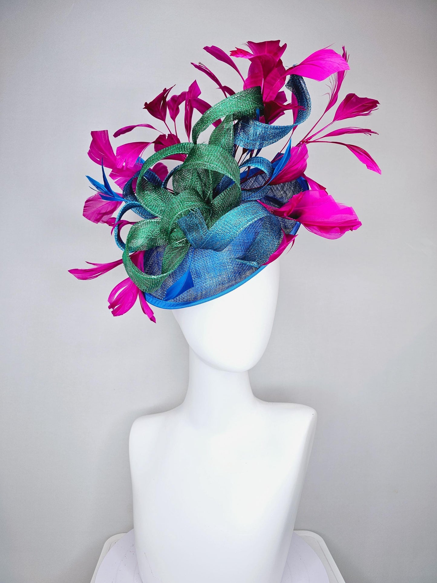 kentucky derby hat fascinator royal blue sinamay saucer with bright fuchsia hot pink branching feathers and green and blue sinamay curls
