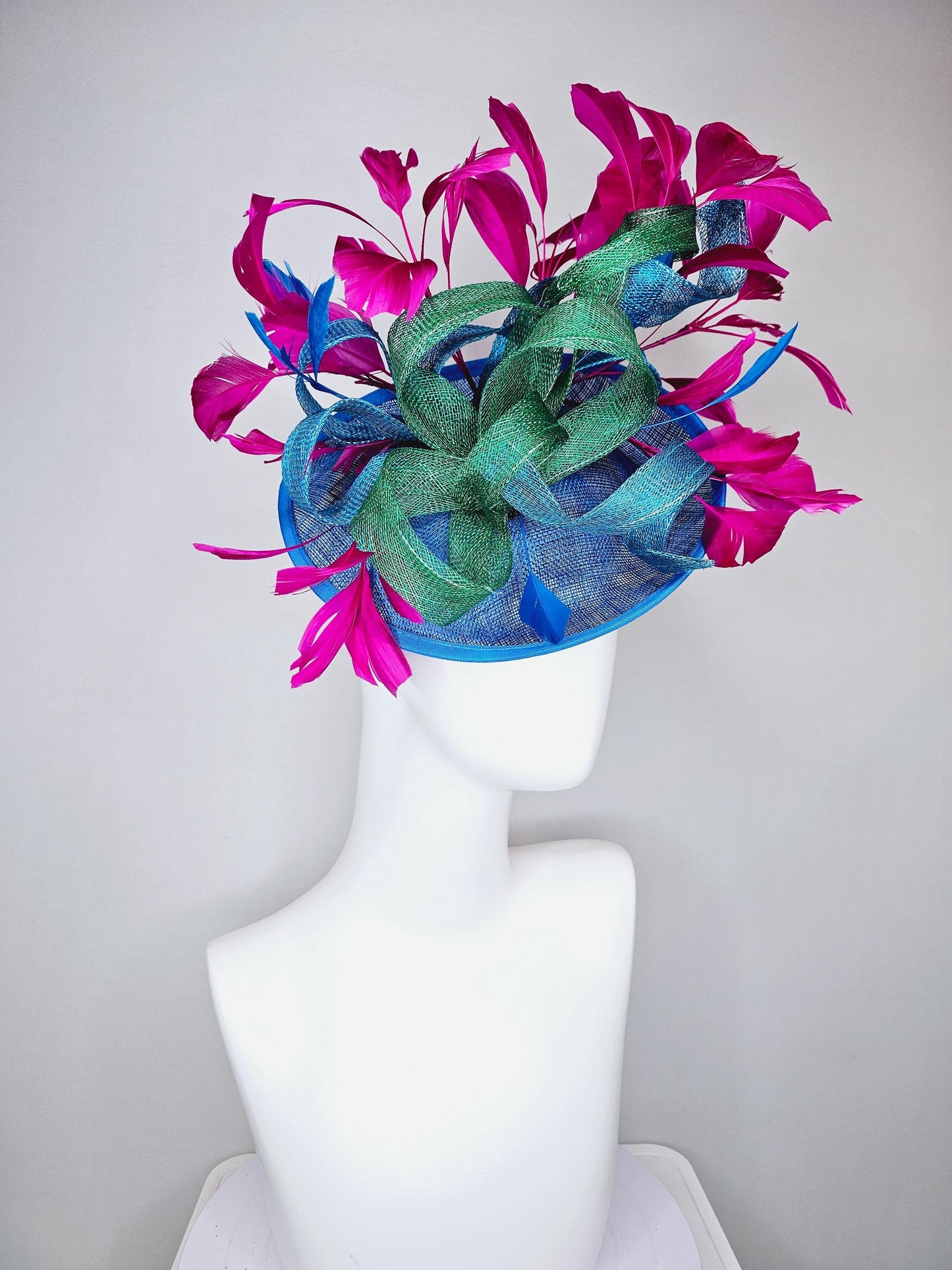 kentucky derby hat fascinator royal blue sinamay saucer with bright fuchsia hot pink branching feathers and green and blue sinamay curls