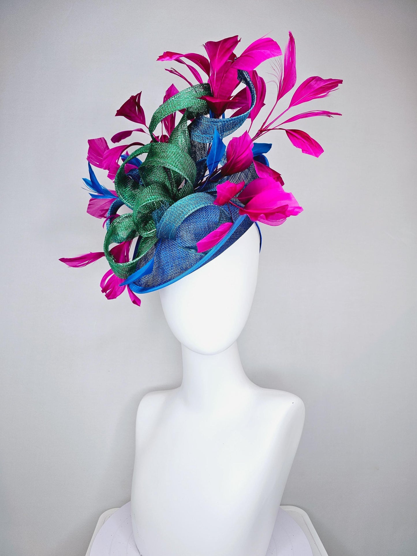 kentucky derby hat fascinator royal blue sinamay saucer with bright fuchsia hot pink branching feathers and green and blue sinamay curls