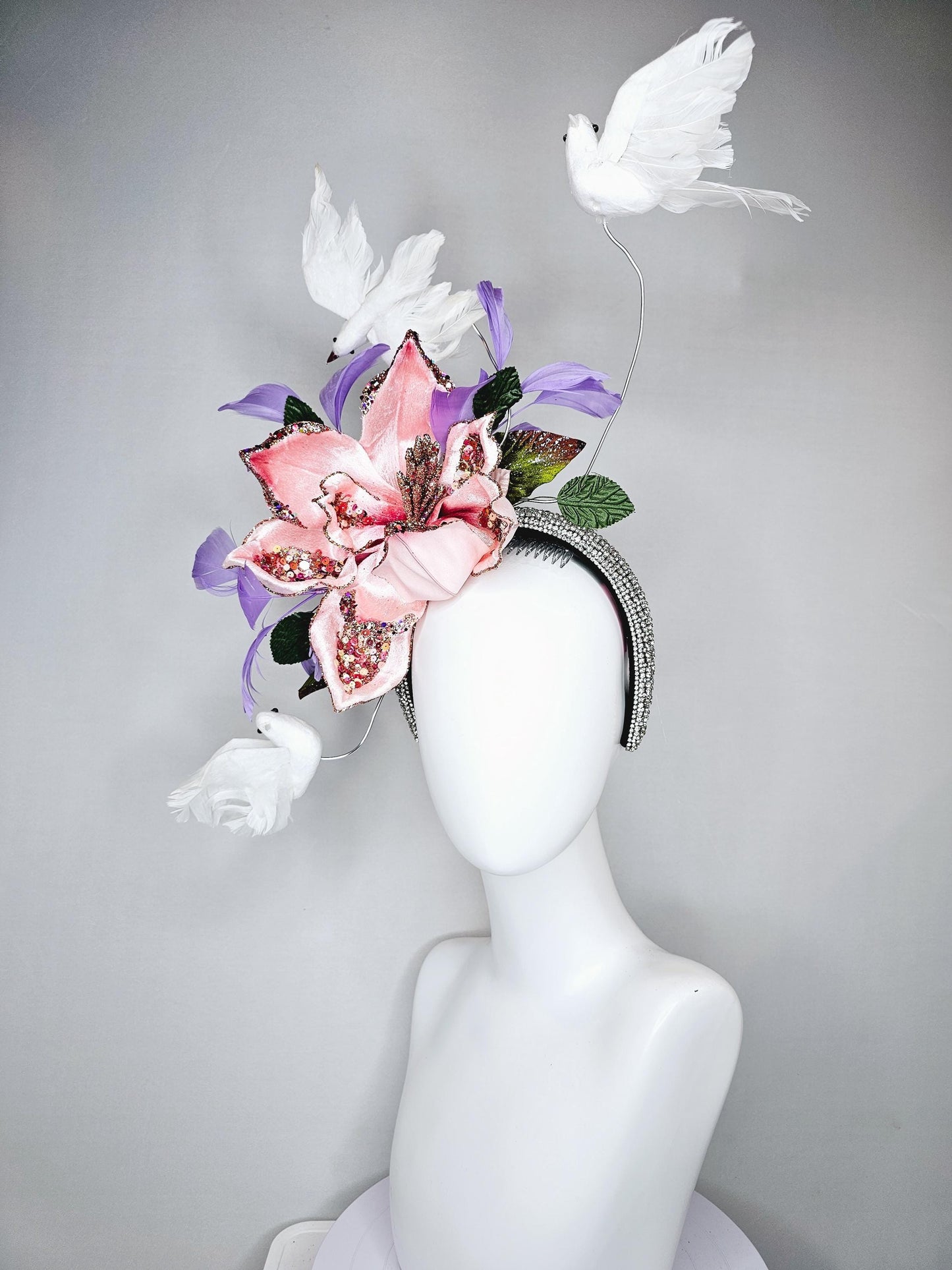 kentucky derby hat fascinator crystal rhinestone headband with light pink sparkle flower, purple lavender feathers and white feather birds