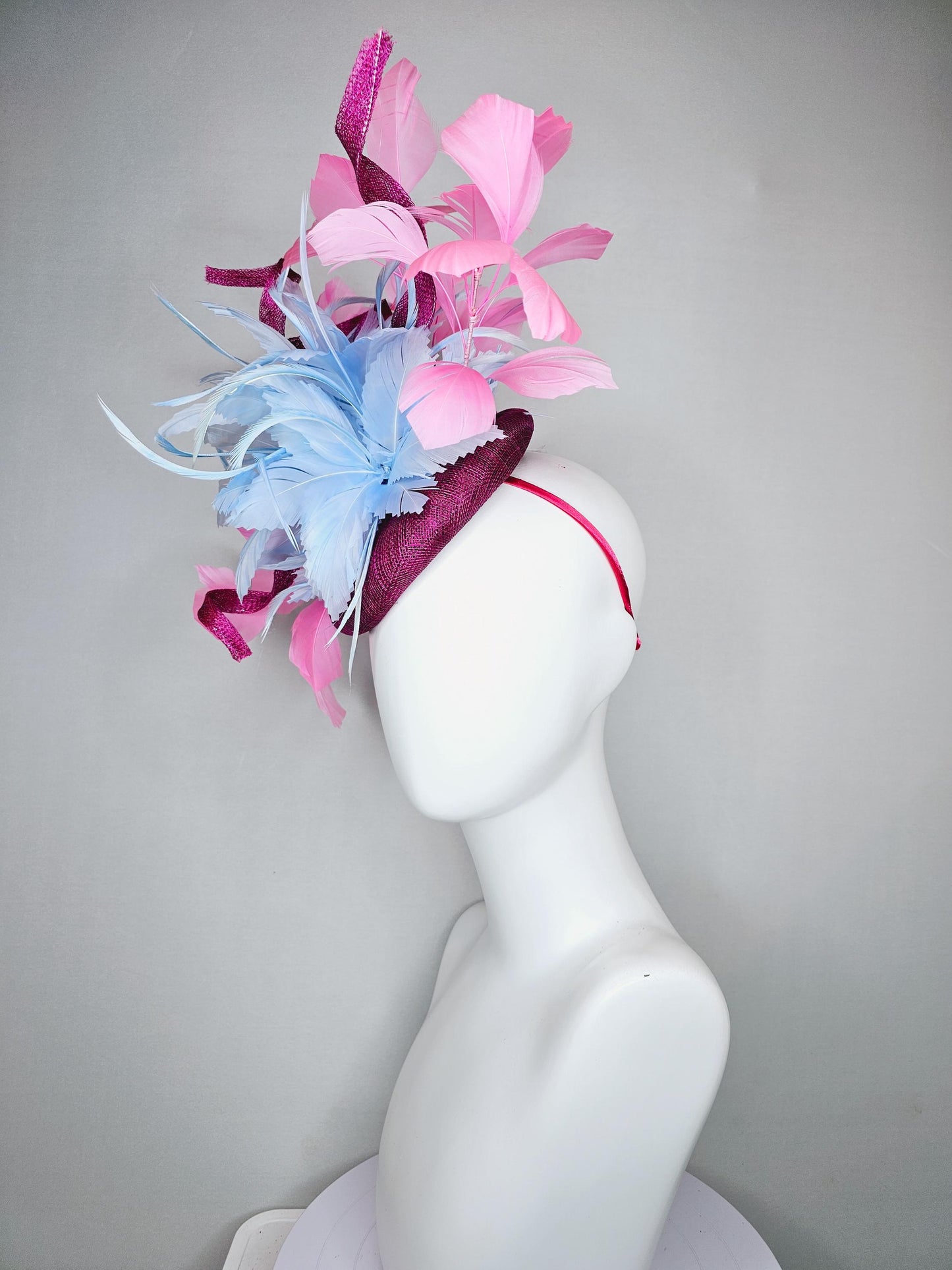 kentucky derby hat fascinator dark fuchsia purple sinamay with large light blue feather flower and light pink feathers with sinamay curls