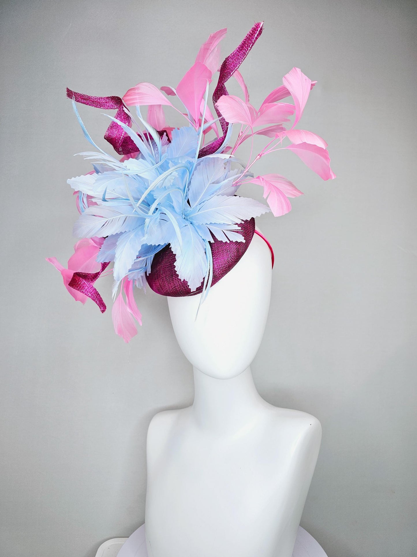 kentucky derby hat fascinator dark fuchsia purple sinamay with large light blue feather flower and light pink feathers with sinamay curls