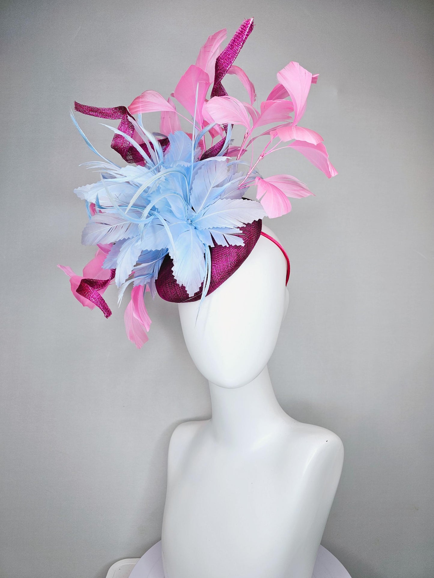kentucky derby hat fascinator dark fuchsia purple sinamay with large light blue feather flower and light pink feathers with sinamay curls