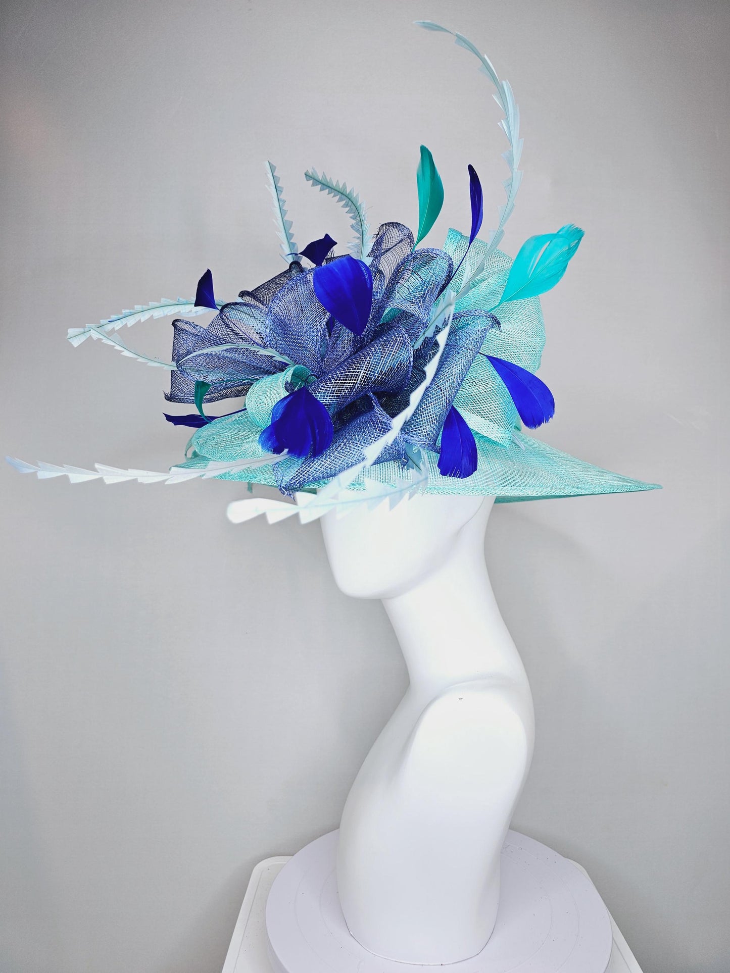 kentucky derby hat wide brim sinamay in teal blue turquoise with large royal blue sinamay bow and light blue and royal blue feathers