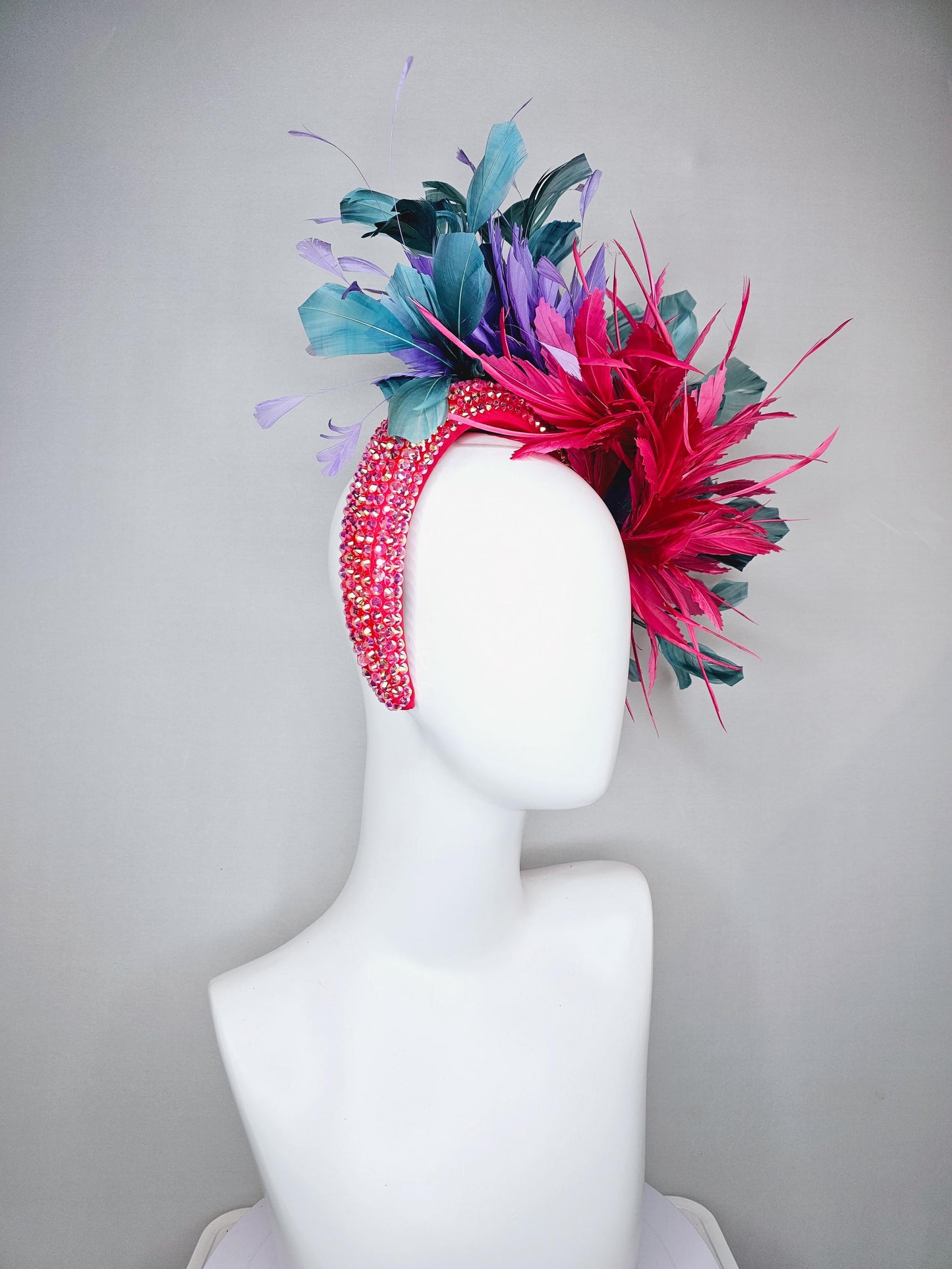 kentucky derby hat fascinator branching hot pink,blue teal,and purple feathers on iridescent Swarovski crystal coral pink headband