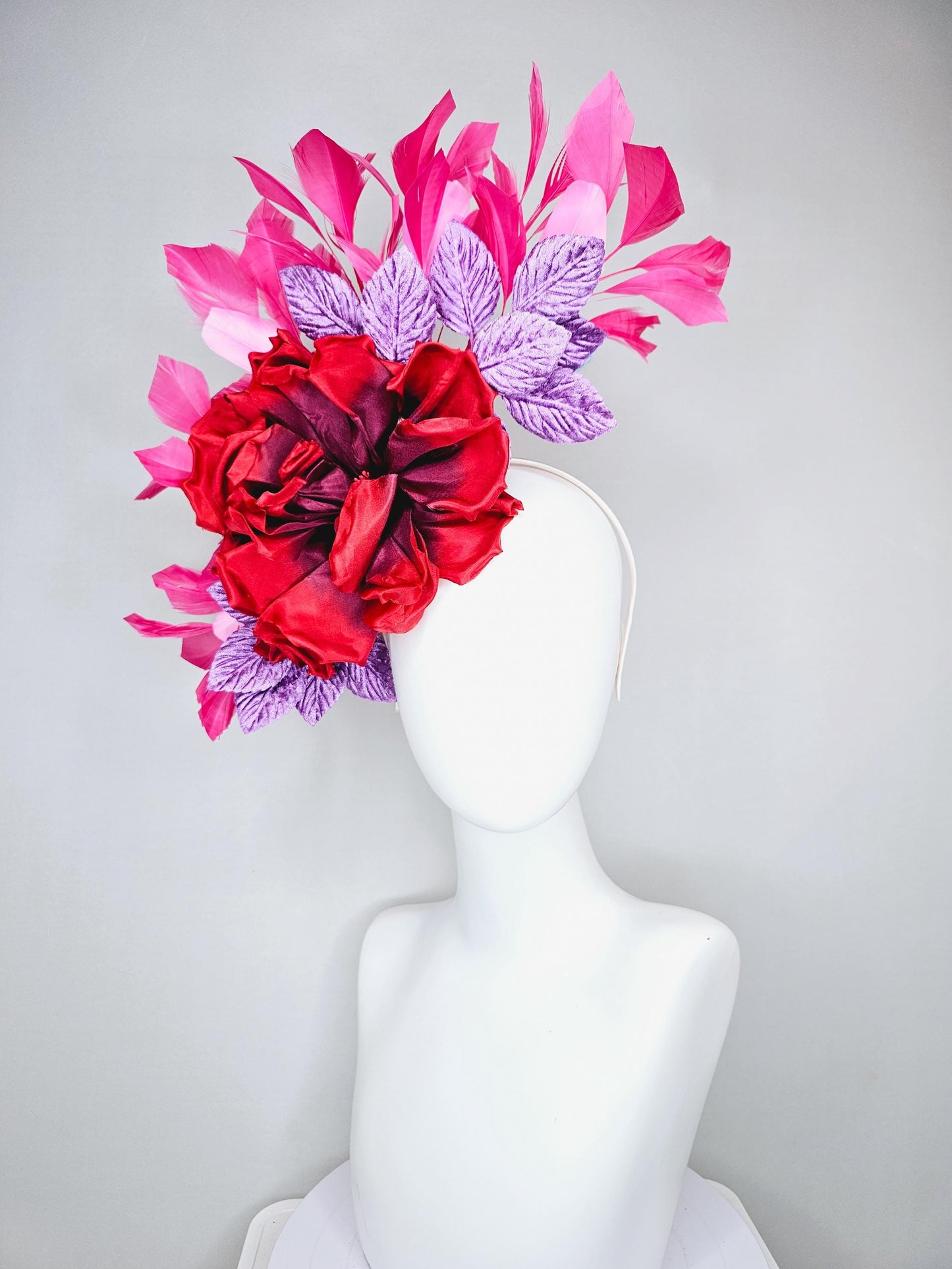 kentucky derby hat fascinator with large red satin silk flower with purple lavender velvet leaves,and branching pink feathers