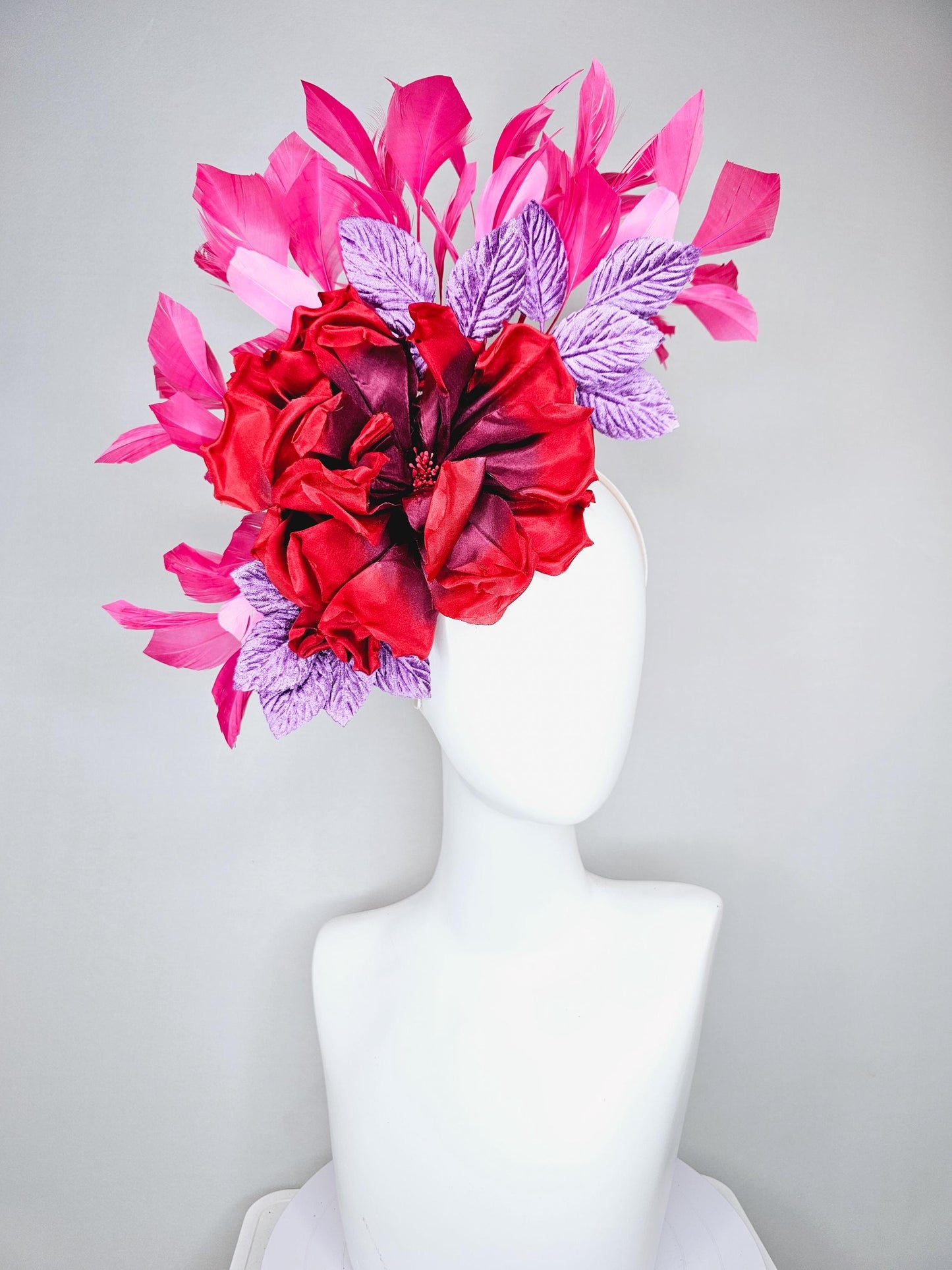 kentucky derby hat fascinator with large red satin silk flower with purple lavender velvet leaves,and branching pink feathers