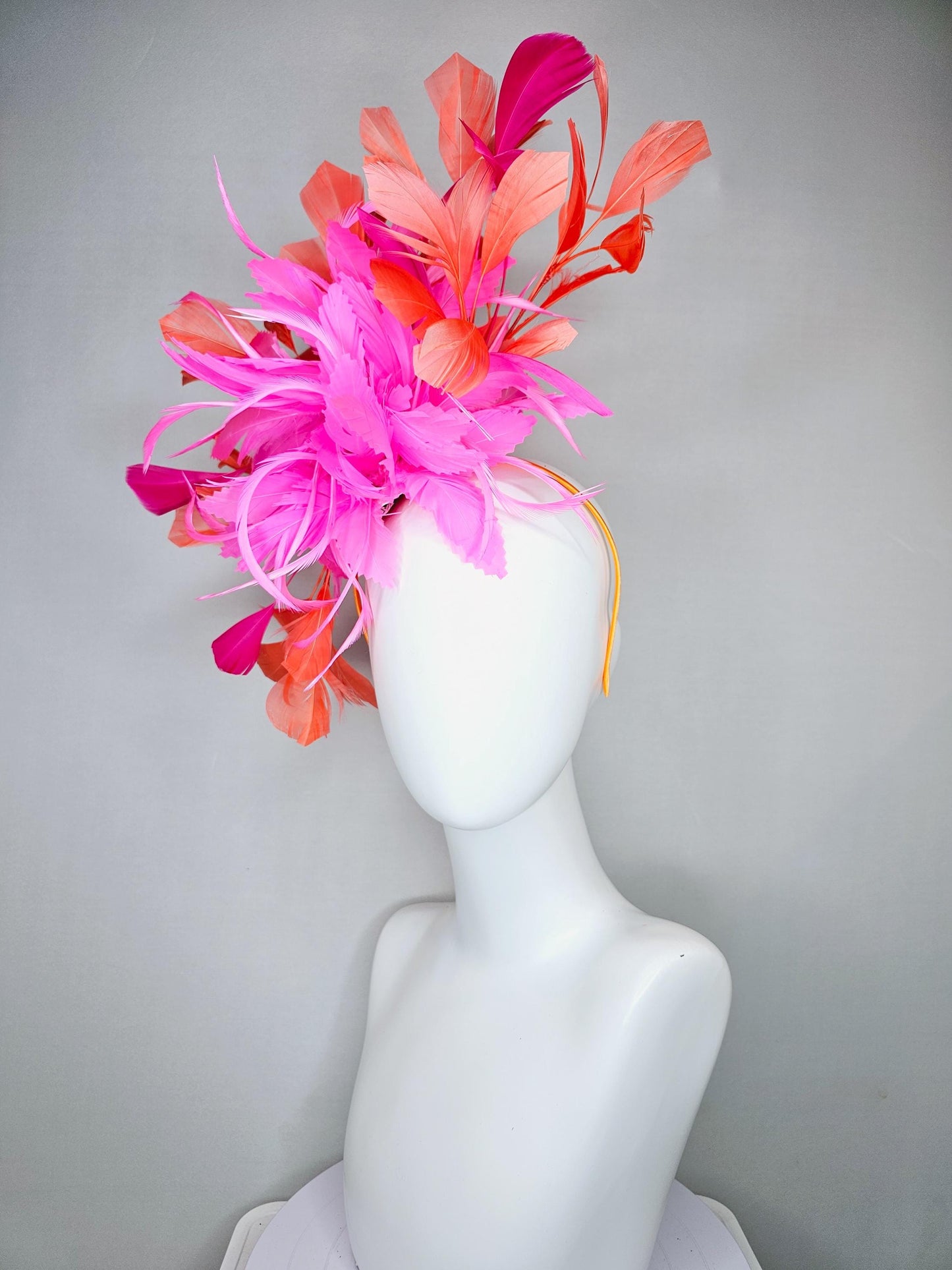 kentucky derby hat fascinator with bright pink feather flowers, fuchsia pink and orange coral branching feathers