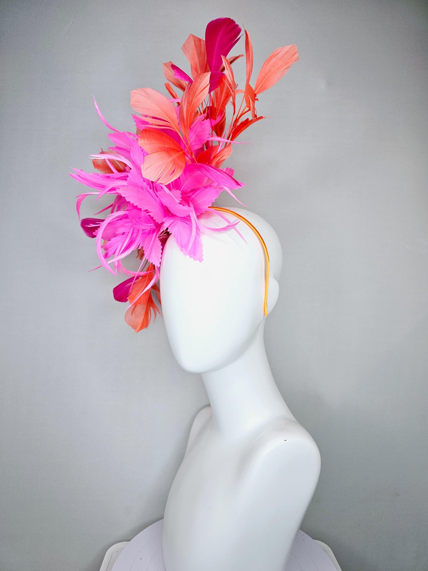 kentucky derby hat fascinator with bright pink feather flowers, fuchsia pink and orange coral branching feathers