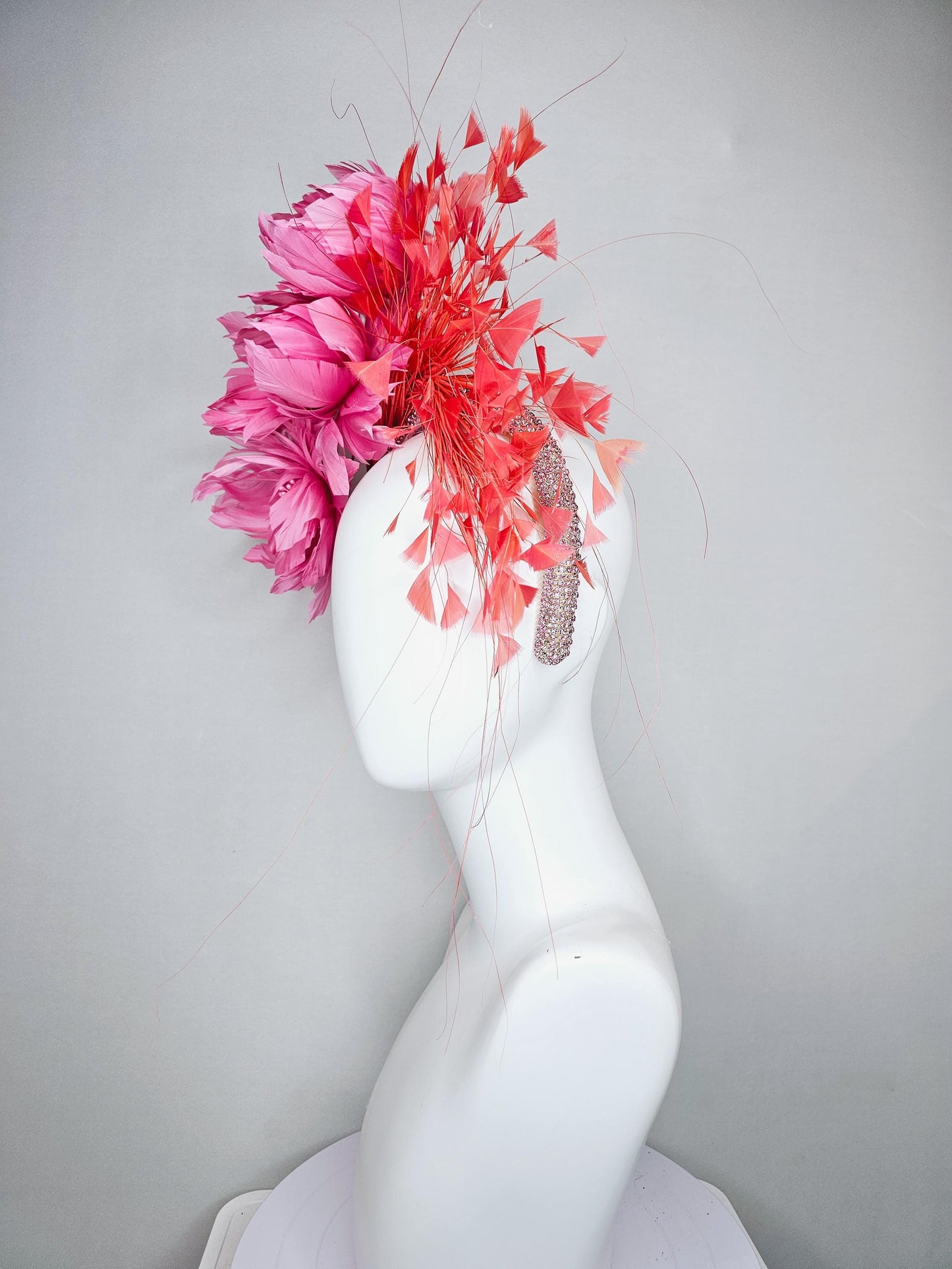 kentucky derby hat fascinator with rose pink feather flowers, light orange coral branching feathers, light pink crystal rhinestone headband