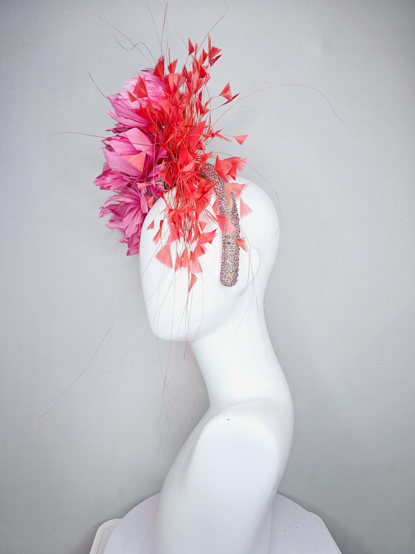 kentucky derby hat fascinator with rose pink feather flowers, light orange coral branching feathers, light pink crystal rhinestone headband