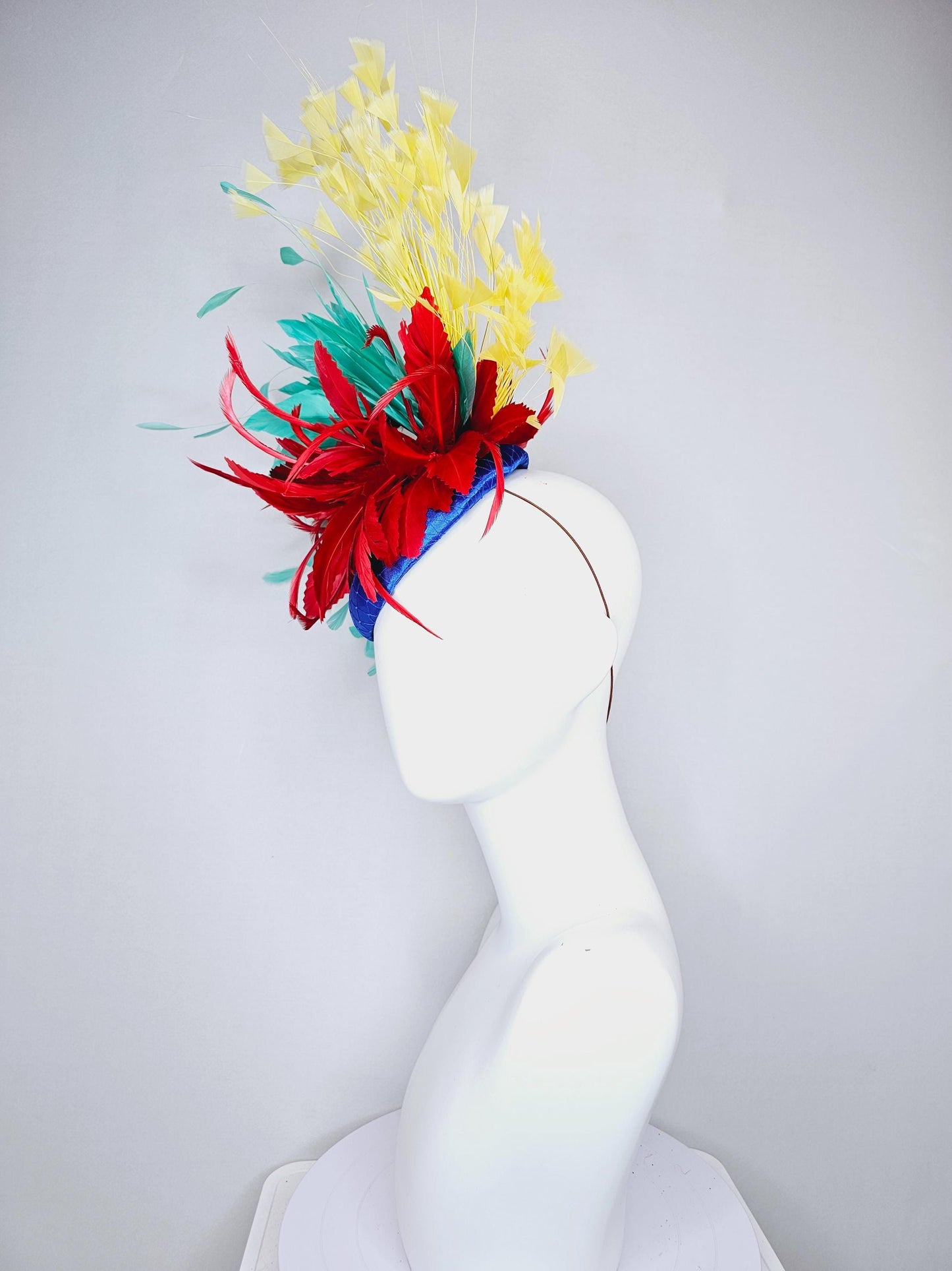 kentucky derby fascinator cobalt royal blue satin with netting,red and turquoise aqua blue feather flower,yellow branching feathers