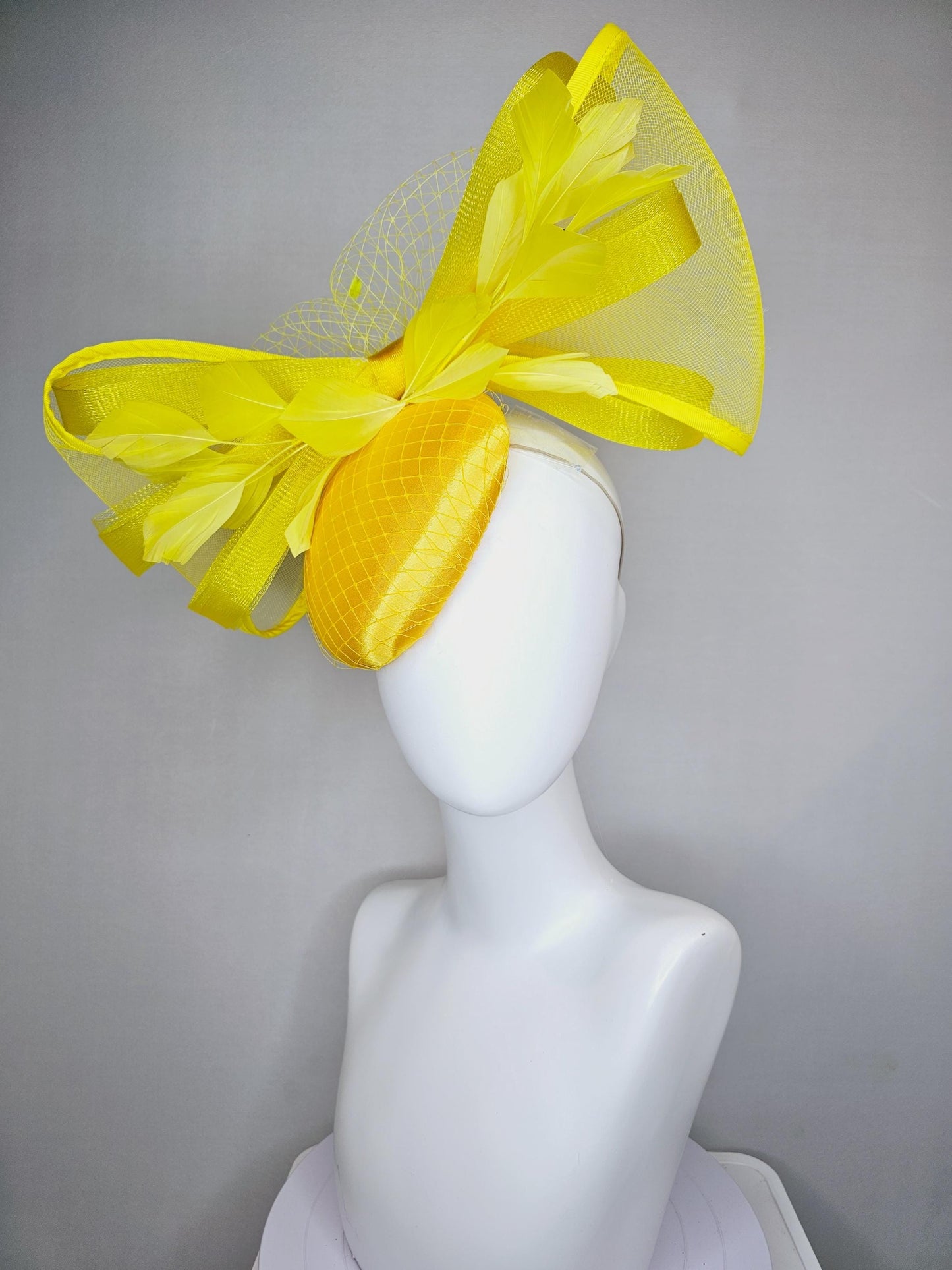 kentucky derby hat fascinator bright yellow satin with netting branching yellow feathers and large mesh yellow bow