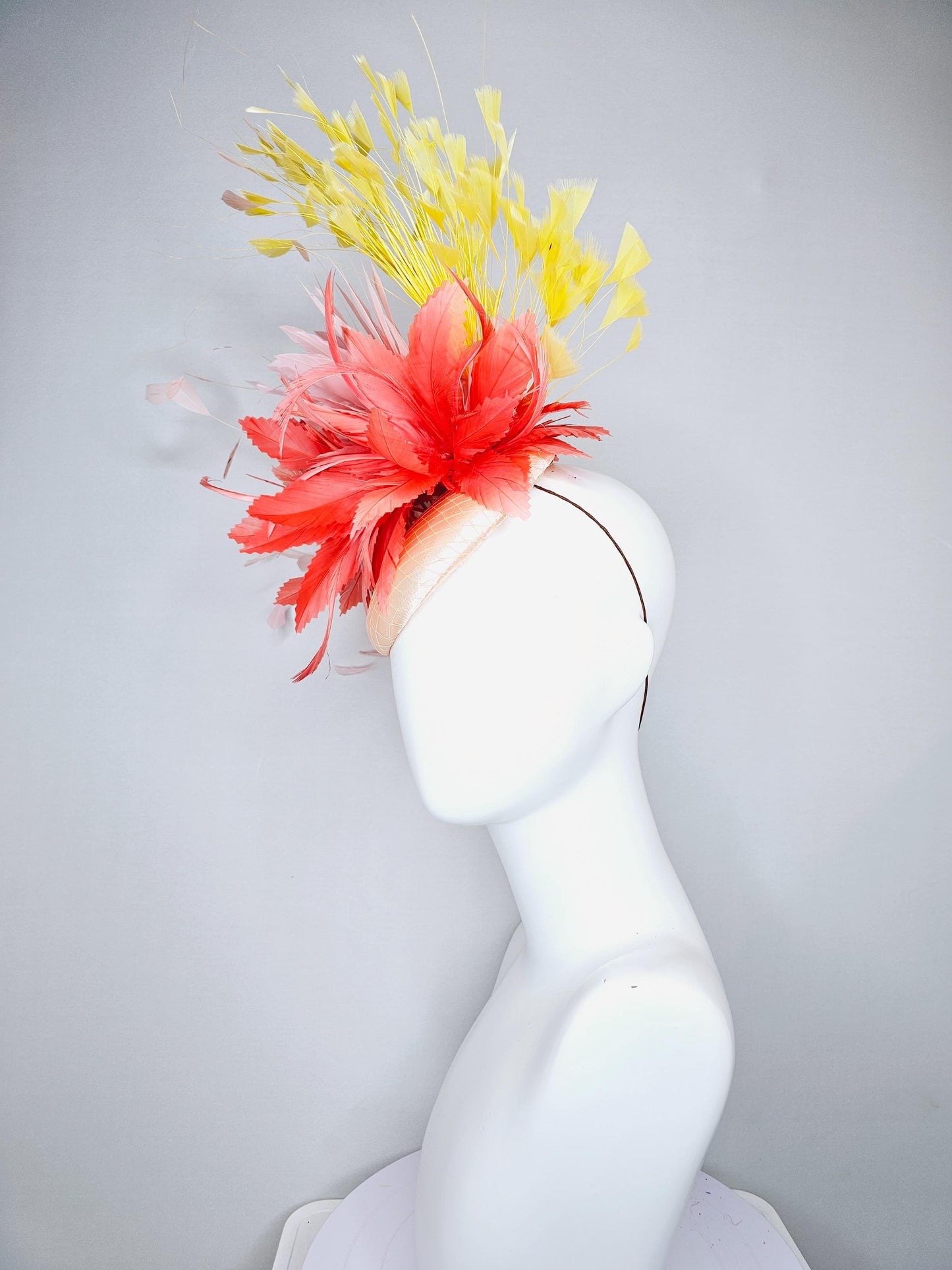 kentucky derby hat fascinator champagne satin with netting coral orange and light blush baby pink feather flower yellow branching feathers