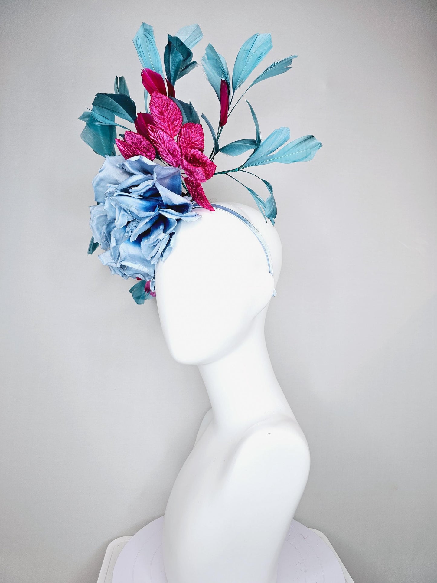 kentucky derby hat fascinator baby blue satin silk flower with fuchsia pink satin leaves and teal blue branching feathers, thin headband