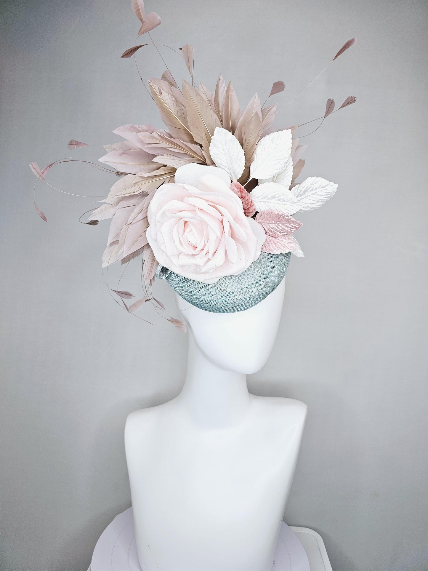 kentucky derby hat fascinator light blue sinamay with light pink satin rose flower, light pink leaves, light brown taupe branching feathers
