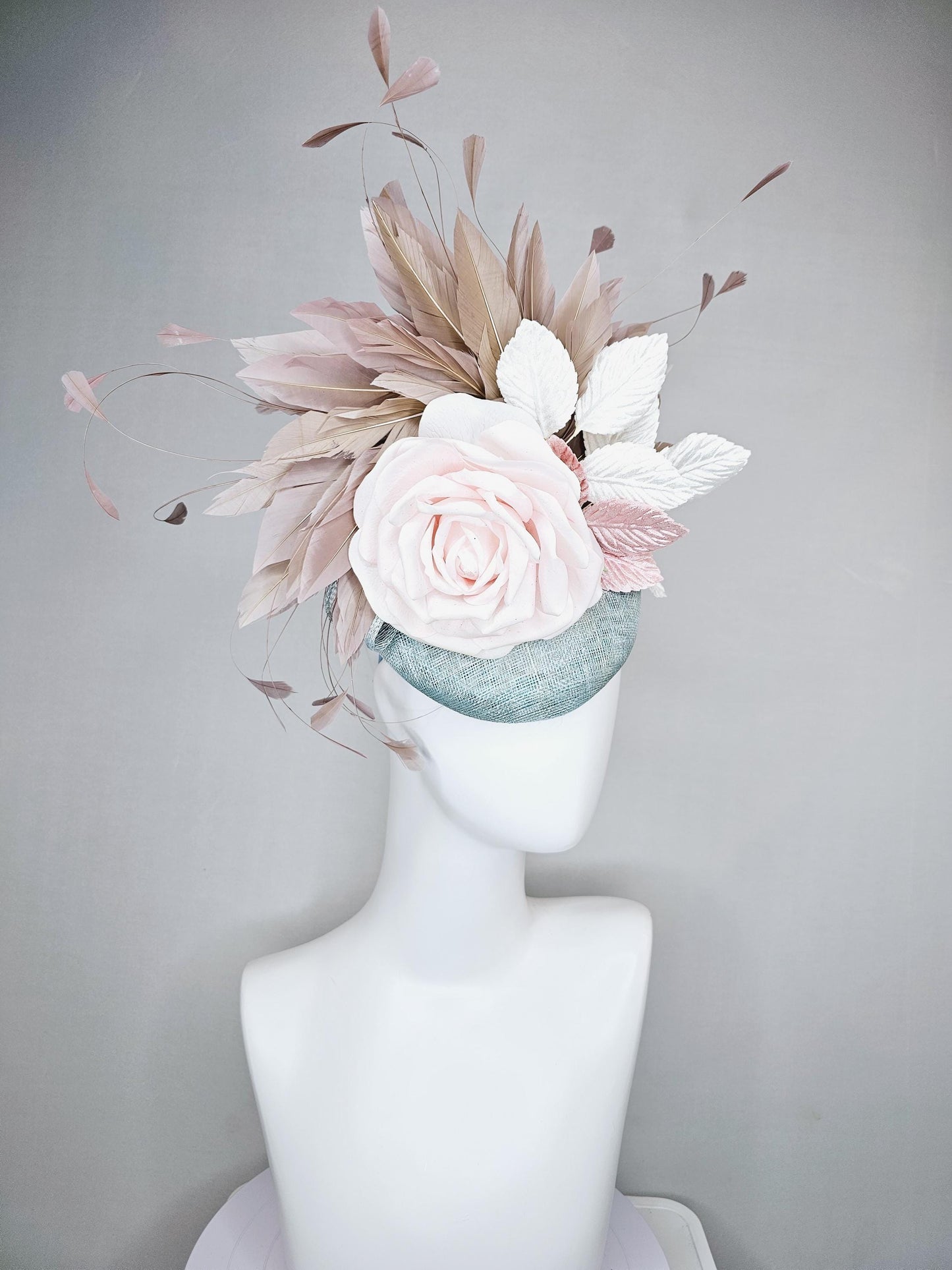 kentucky derby hat fascinator light blue sinamay with light pink satin rose flower, light pink leaves, light brown taupe branching feathers