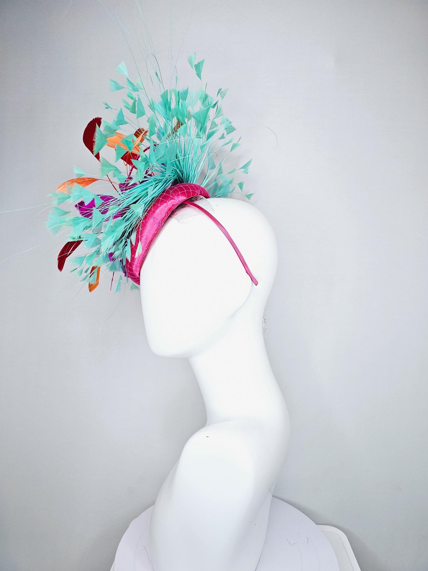 kentucky derby hat fascinator pink satin with netting and fluffy bright pink fuchsia, aqua blue green, red, orange coral branching feathers