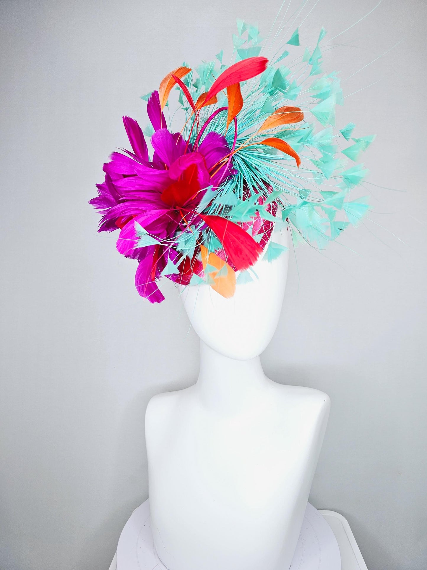 kentucky derby hat fascinator pink satin with netting and fluffy bright pink fuchsia, aqua blue green, red, orange coral branching feathers