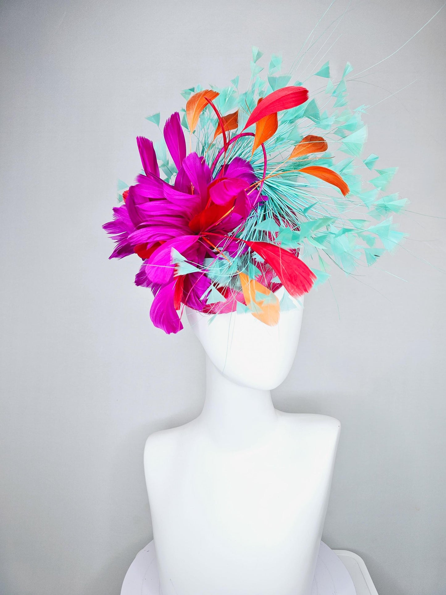 kentucky derby hat fascinator pink satin with netting and fluffy bright pink fuchsia, aqua blue green, red, orange coral branching feathers